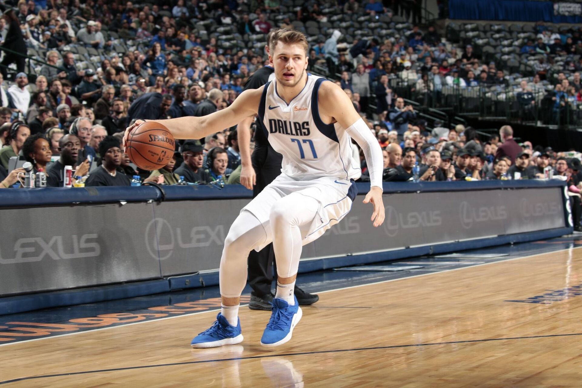Luka Dončić dribbling a basketball on court HD Wallpaper