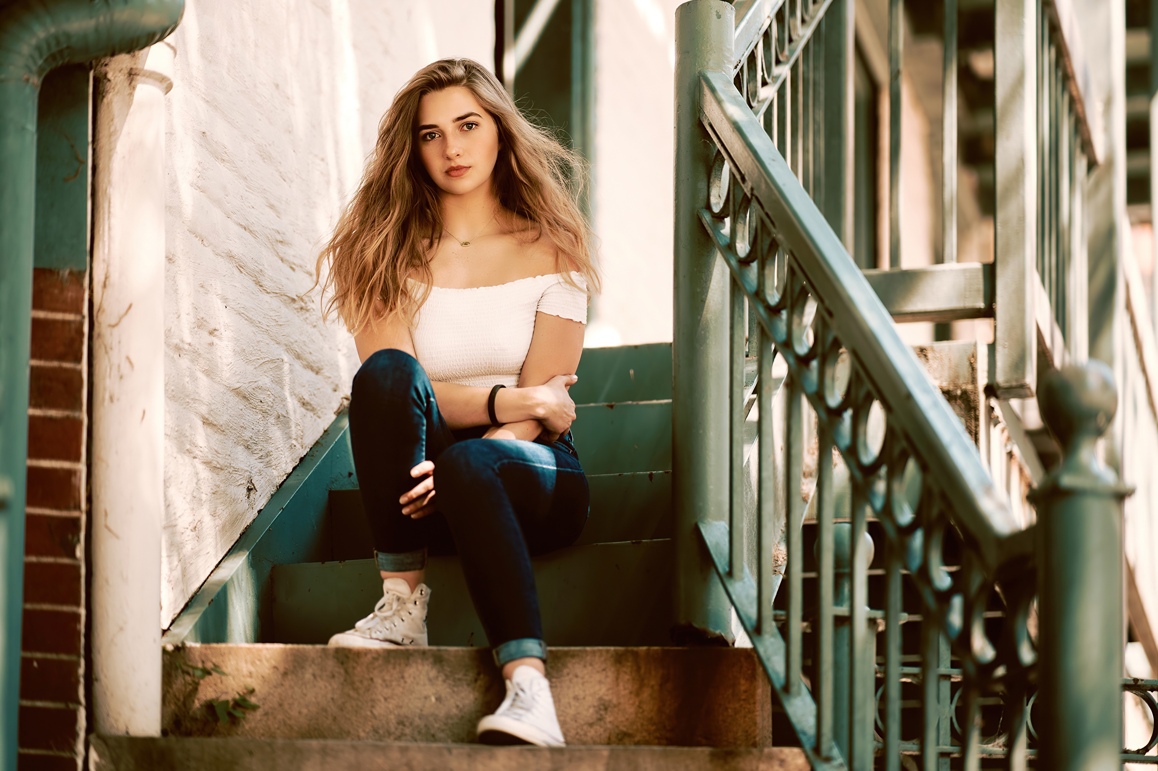 Young woman sitting on stairs HD Wallpaper