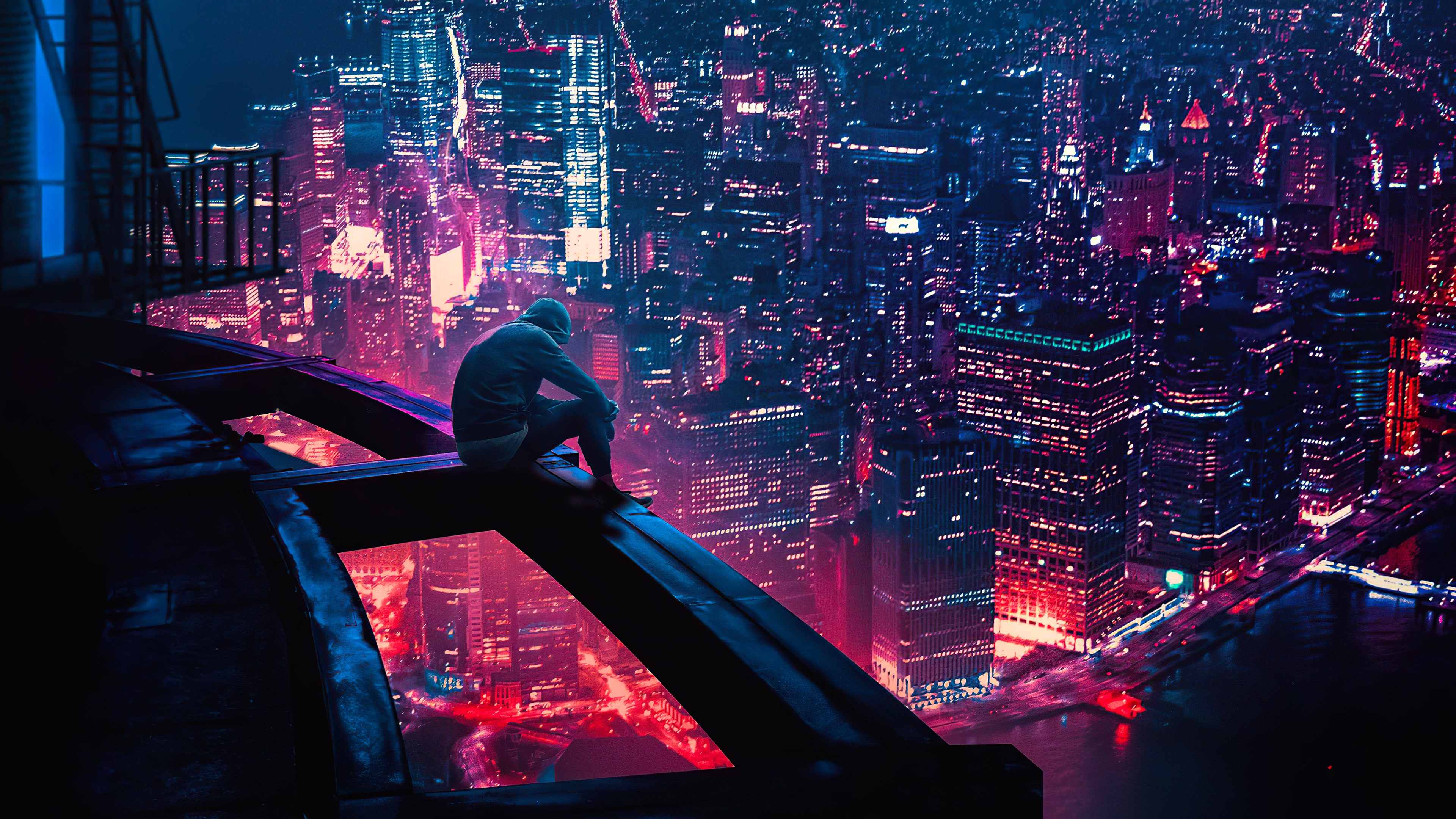 Man on skyscraper overlooking neon city at night HD Wallpaper
