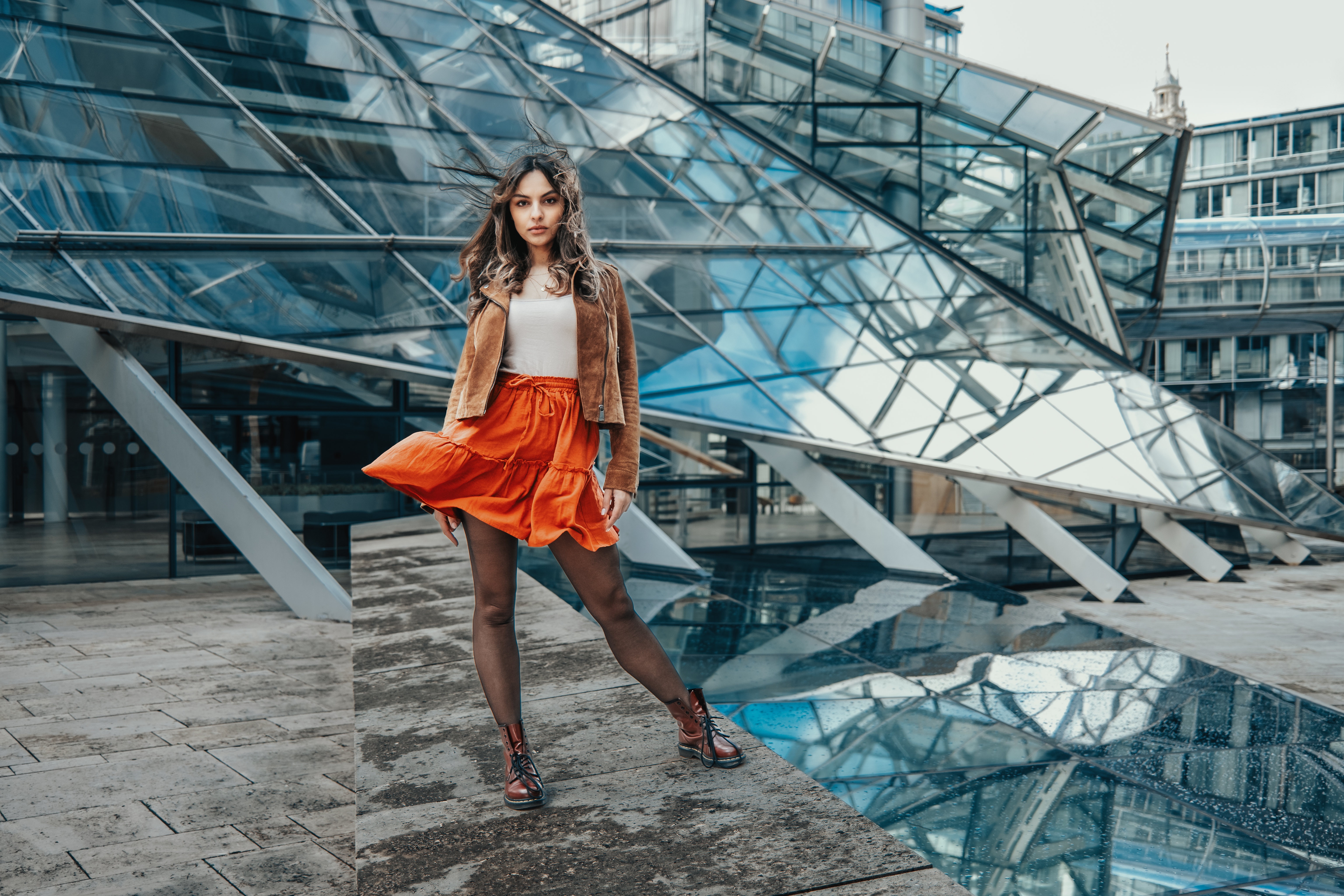 Model in orange skirt and brown jacket HD Wallpaper