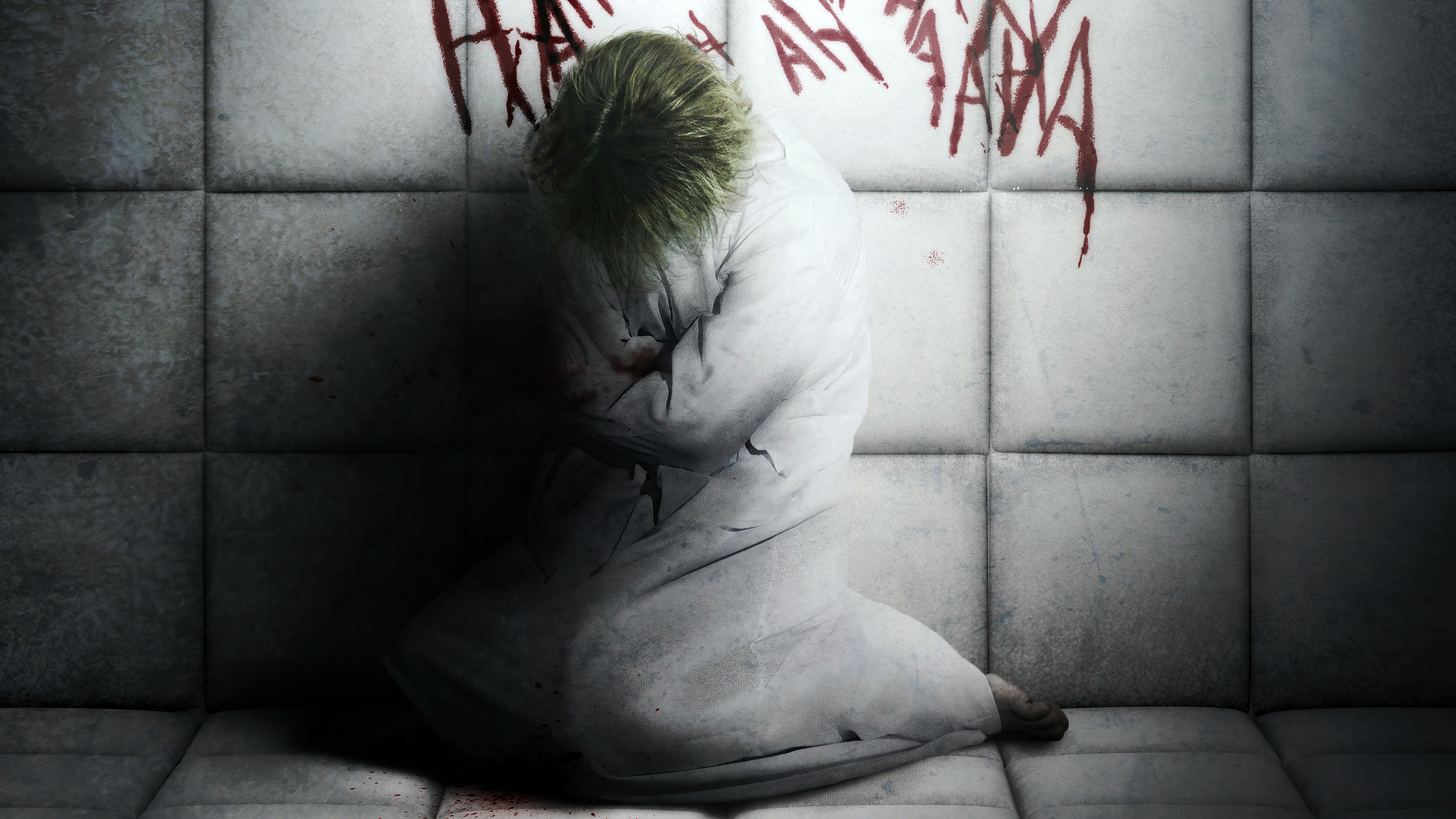Joker in a straitjacket with 'HA HA' written on the wall HD Wallpaper