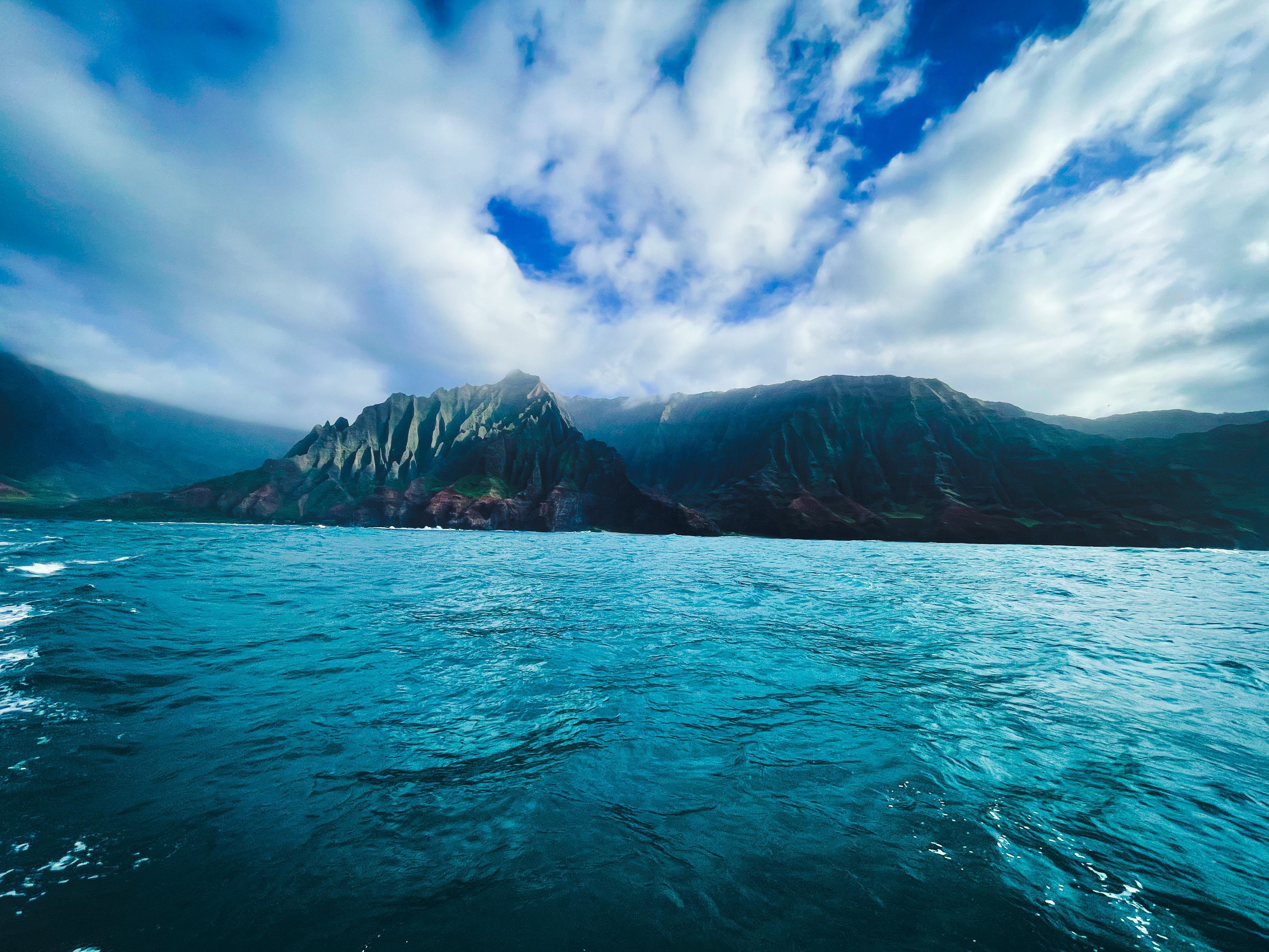 Rugged Coastline Mountains Over Blue Ocean 4K HD Wallpaper