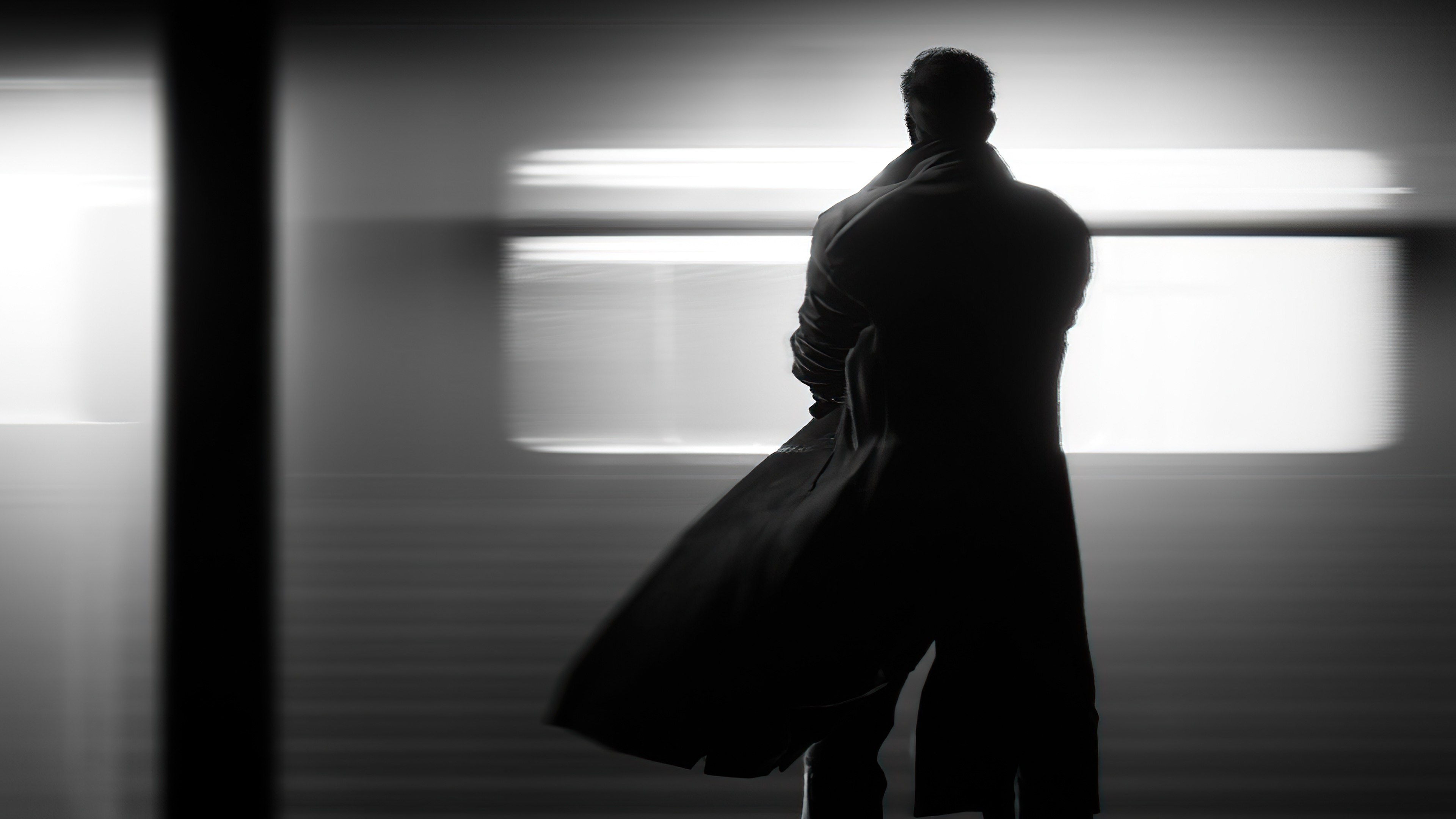 Man in trench coat standing in front of blurred lights HD Wallpaper