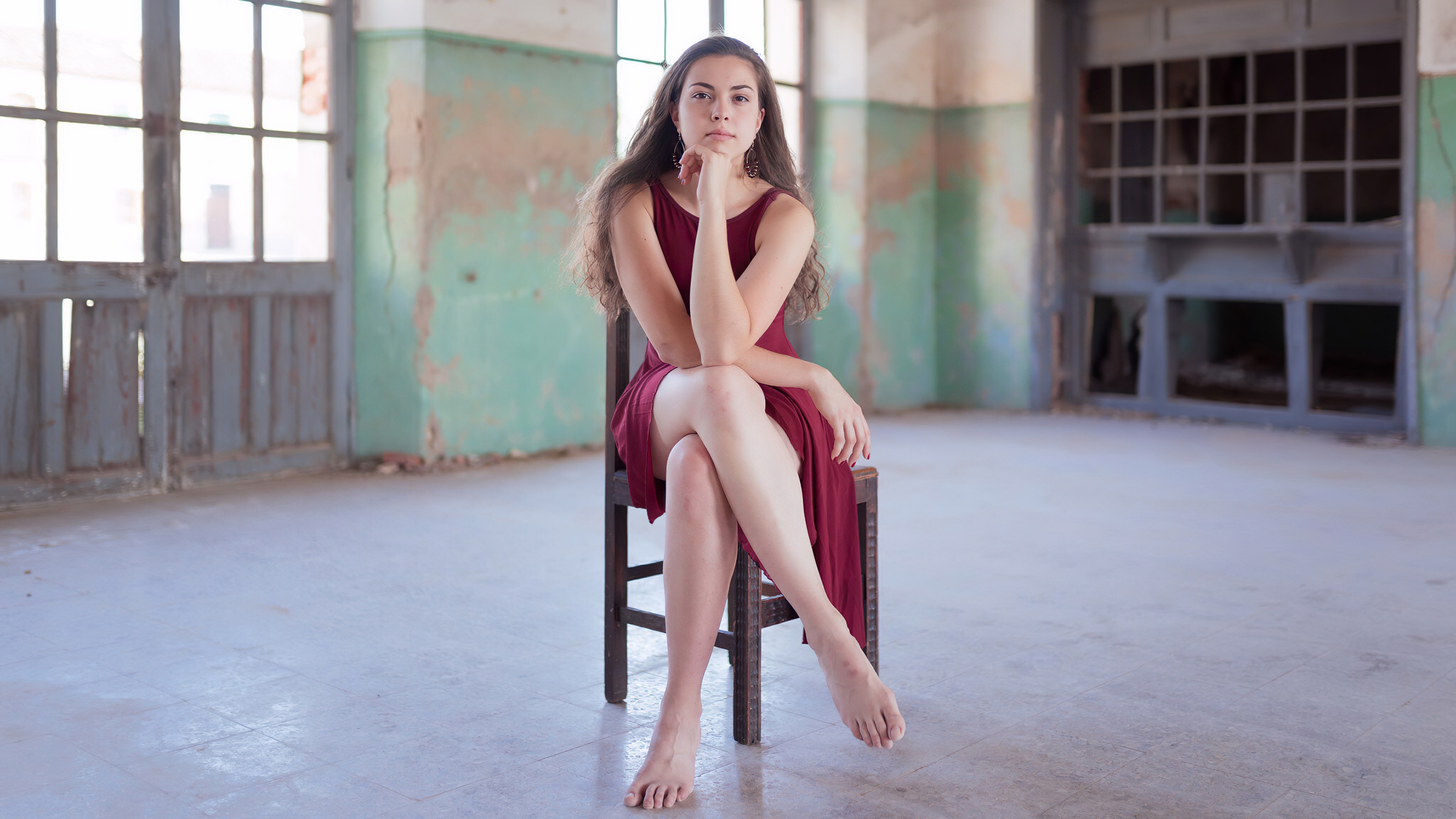 Young woman in a red dress sitting in an abandoned building HD Wallpaper