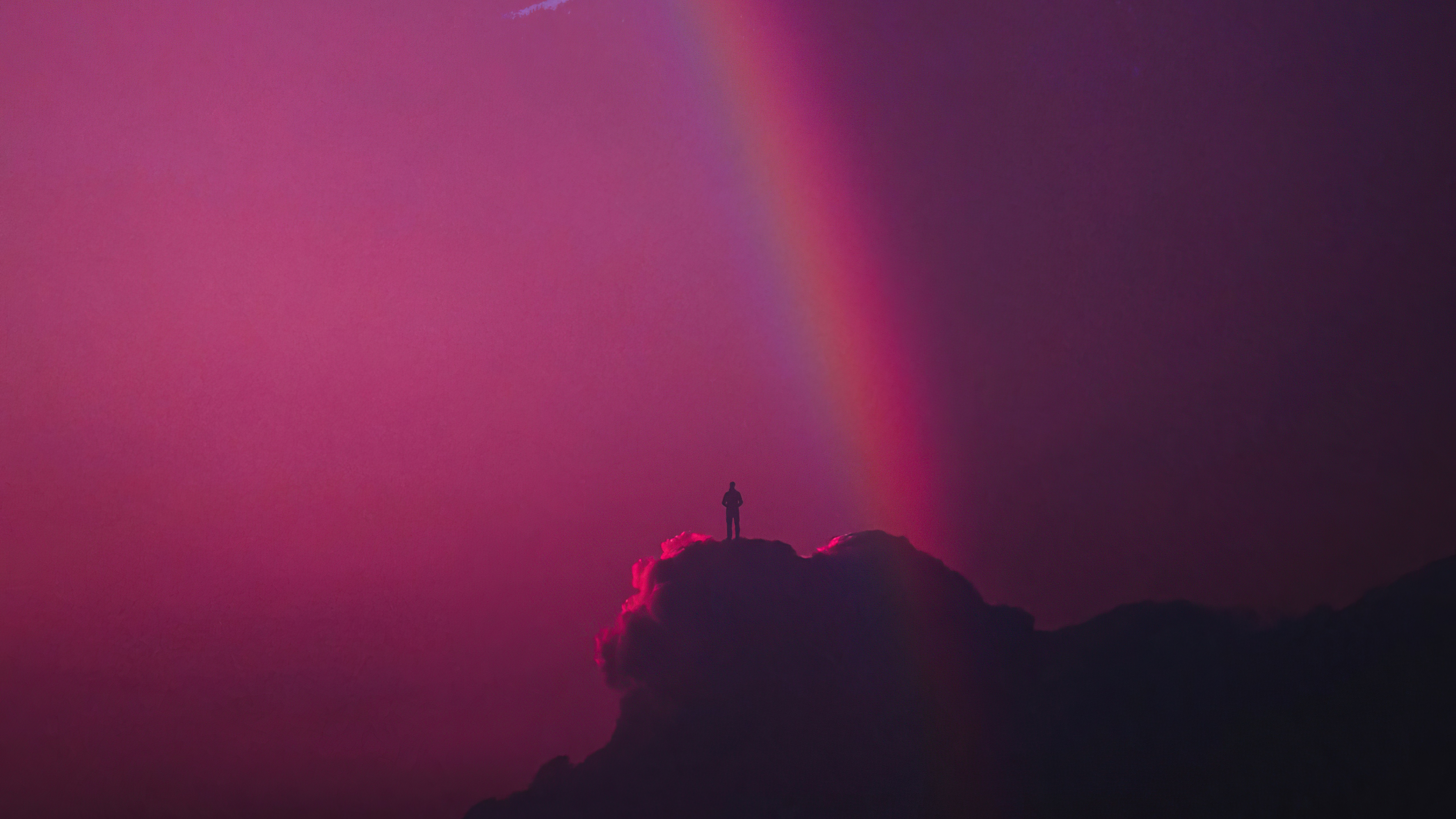 Silhouette of a person on a cloud with a rainbow HD Wallpaper
