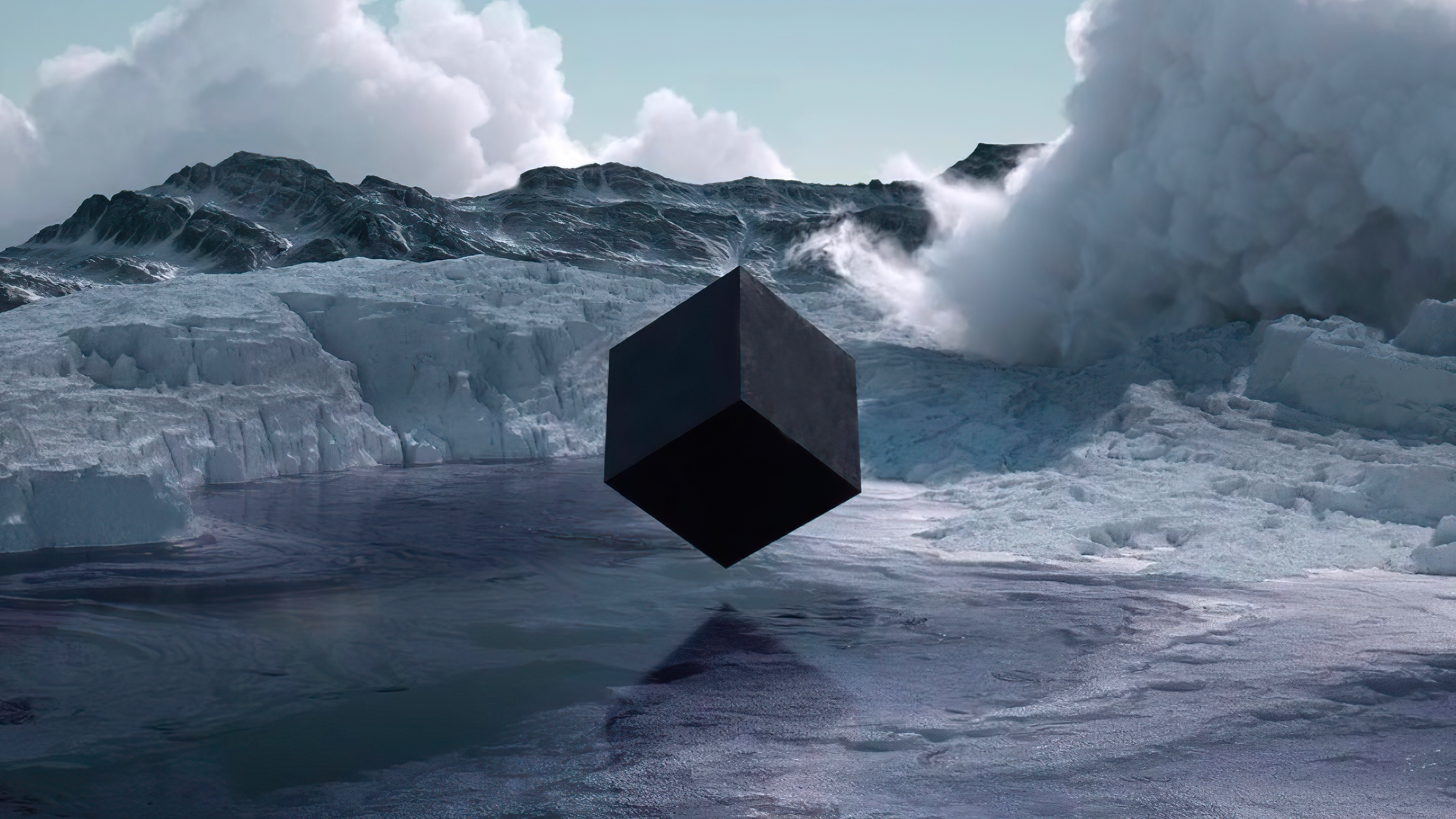 Black cube floating over icy water with mountains HD Wallpaper