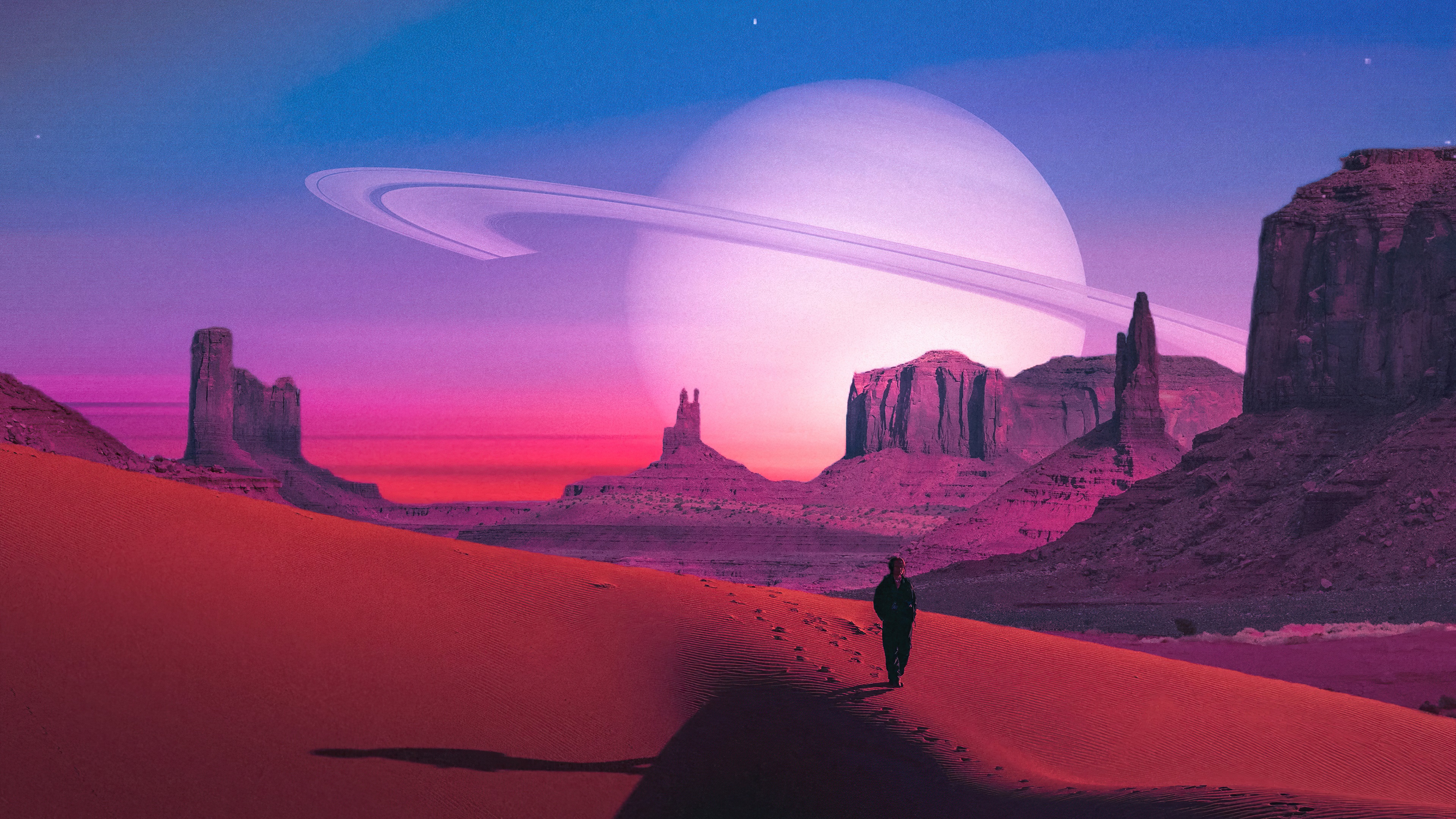Person walking on sand dunes with planet in sky HD Wallpaper