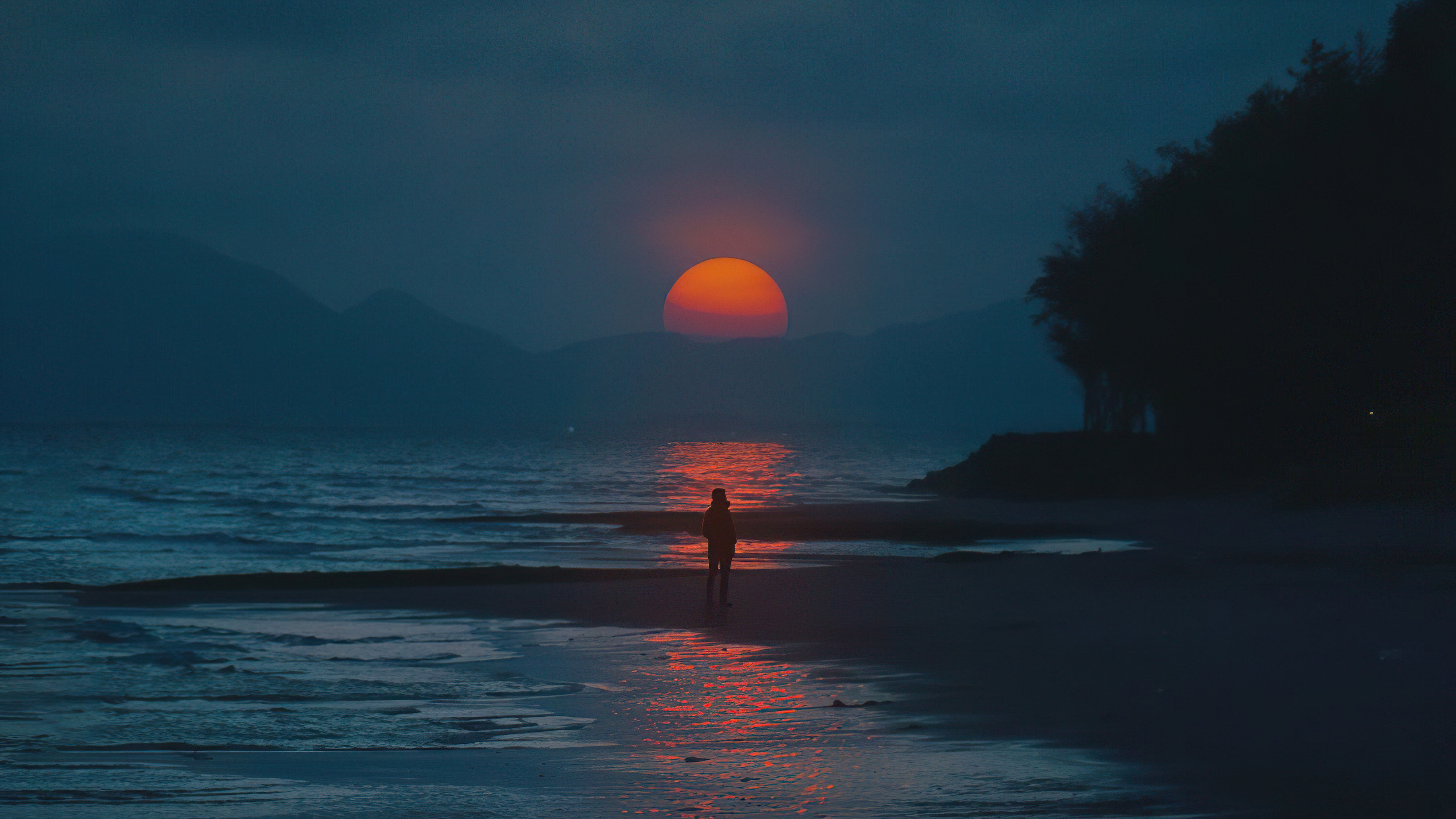 Person on beach watching sunset over ocean HD Wallpaper