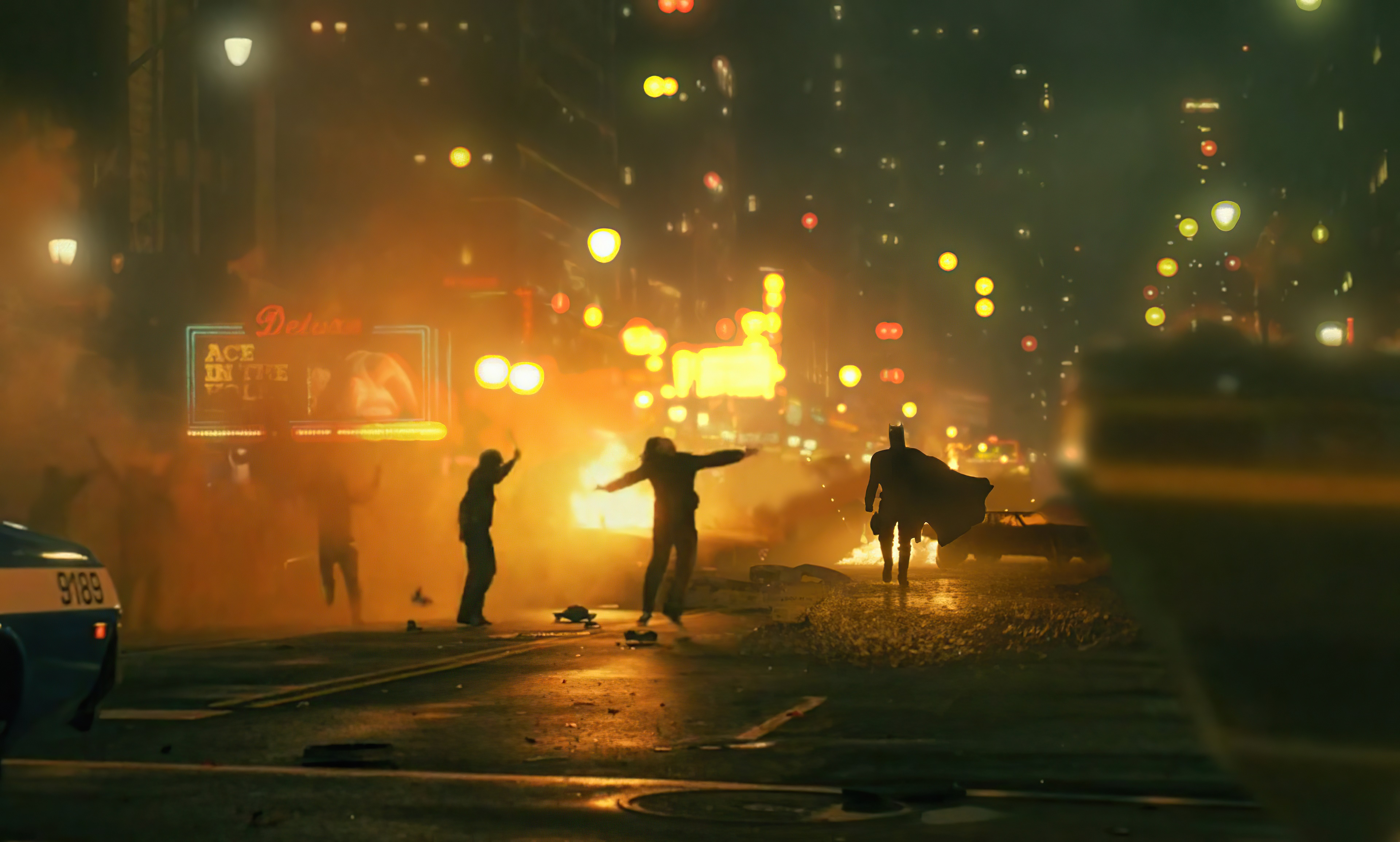 Batman in a burning city street HD Wallpaper