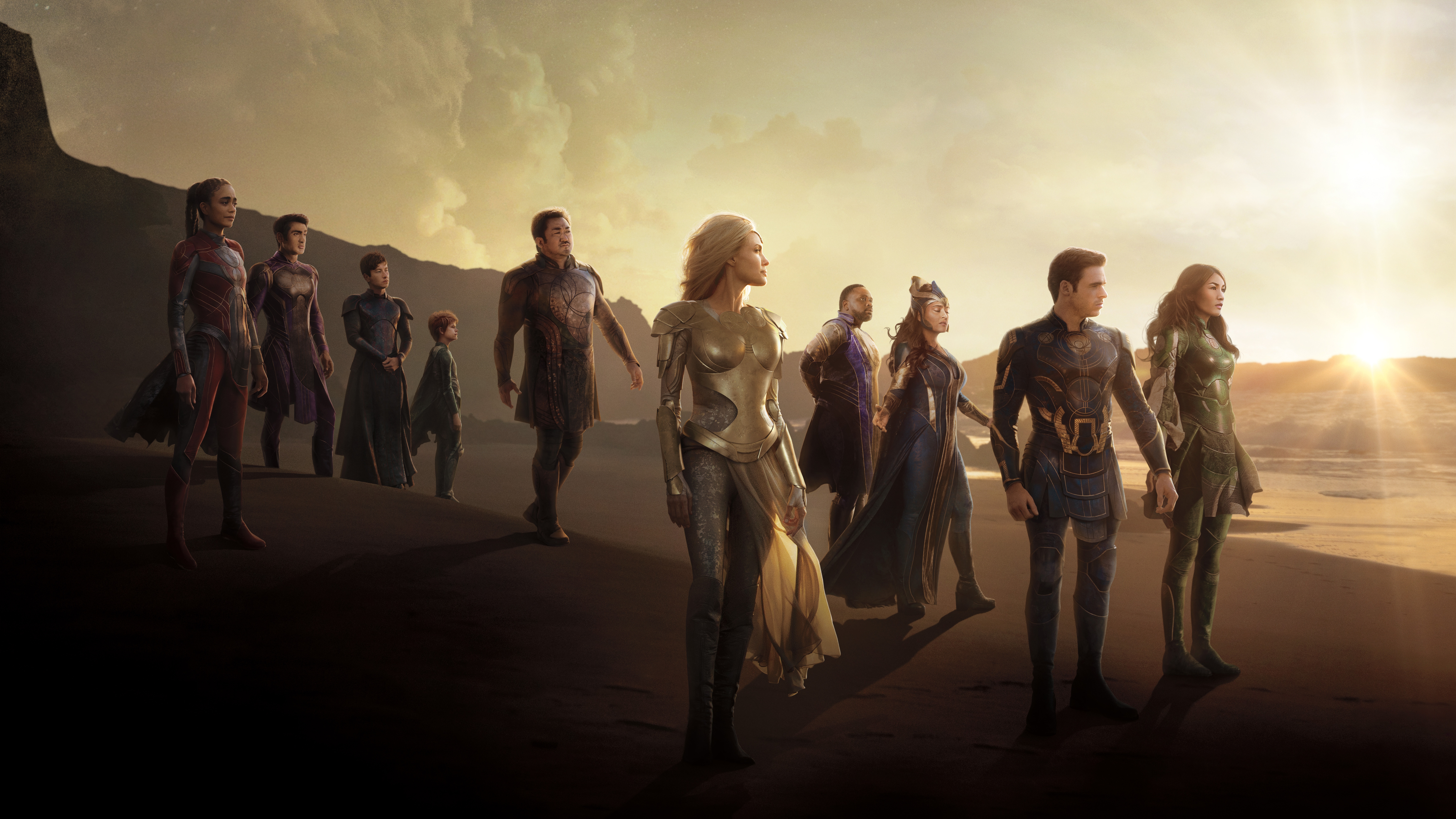 The Eternals standing on a beach at sunset HD Wallpaper