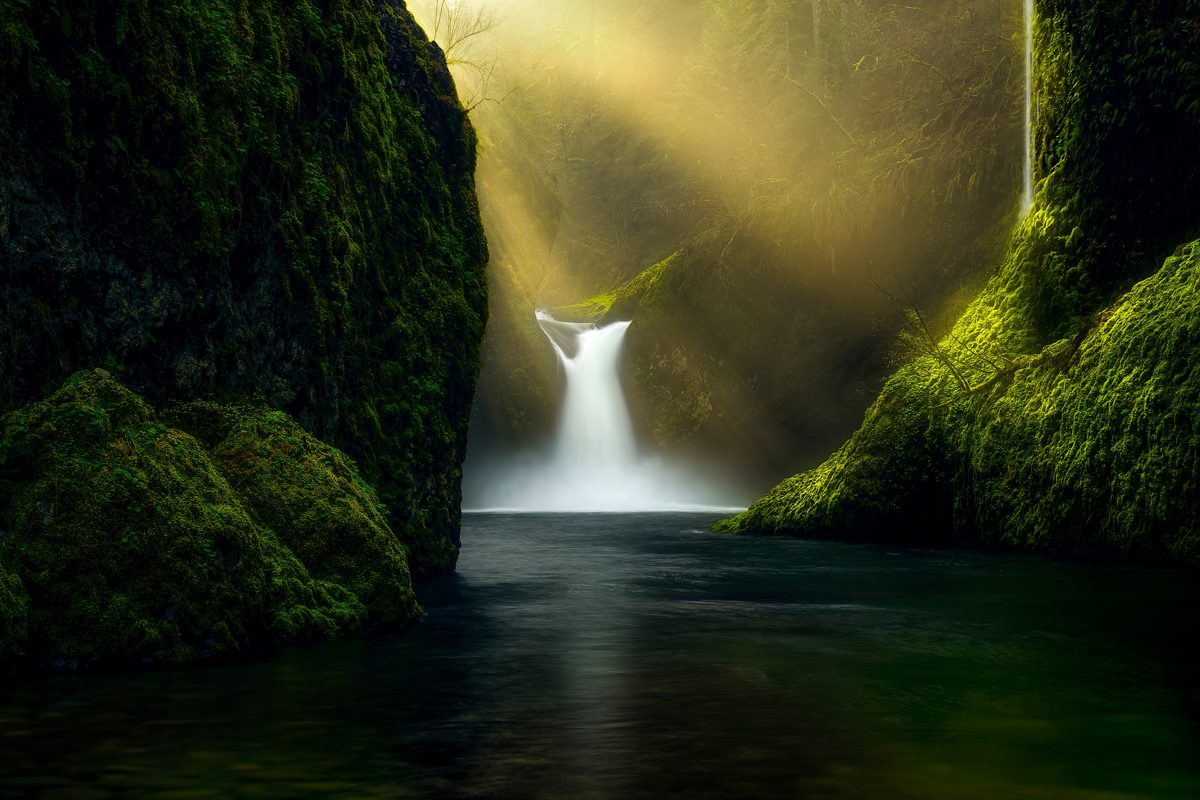 Waterfall in a mossy canyon with sunbeams HD Wallpaper