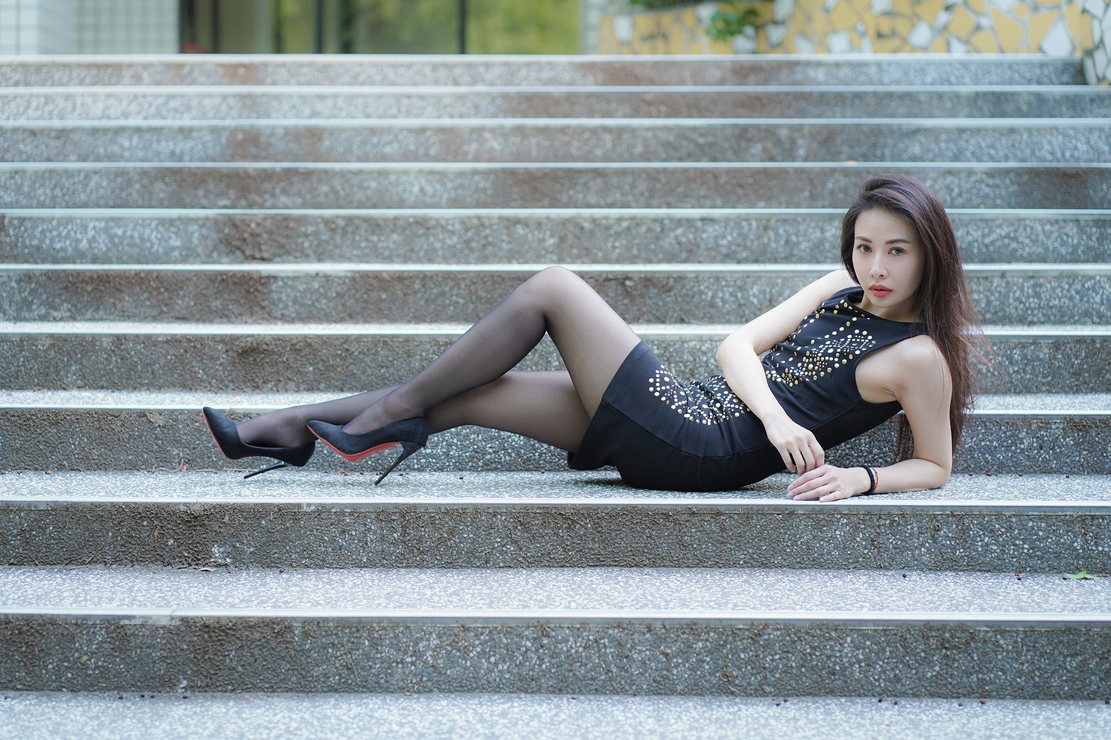 Asian woman in black dress lying on stairs HD Wallpaper