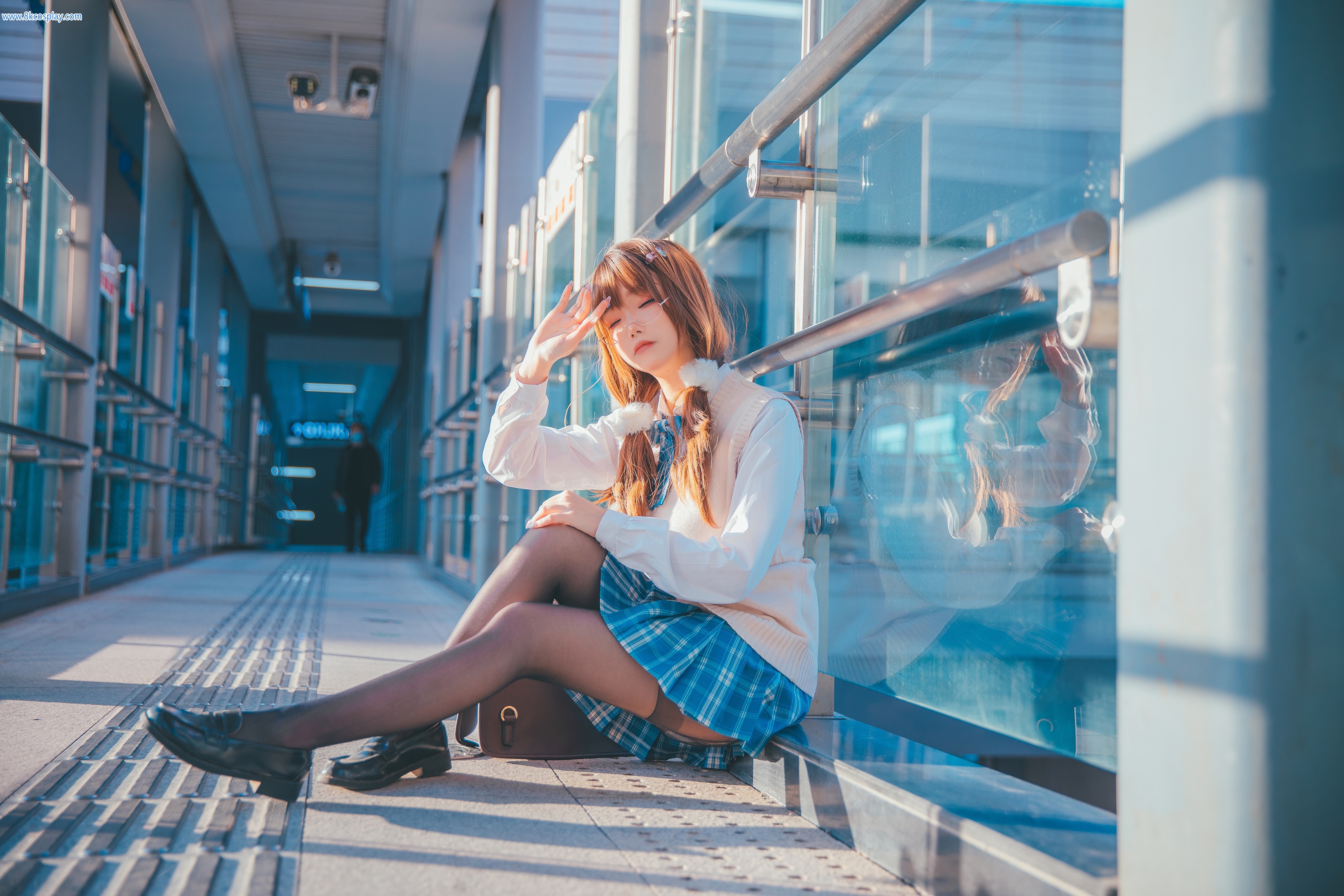 Asian girl in school uniform sitting by glass railing HD Wallpaper