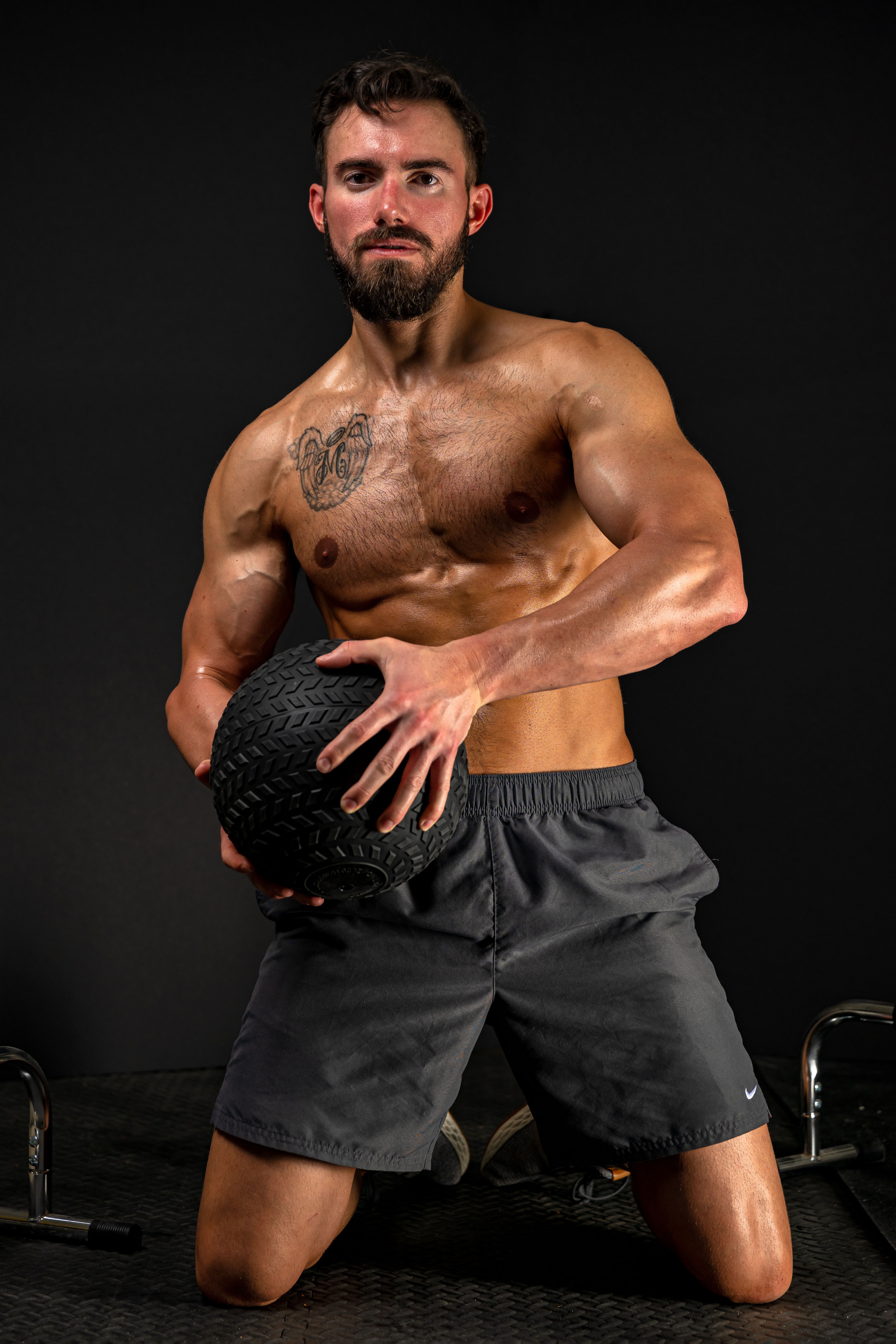 Man holding a medicine ball during a workout HD Phone Wallpaper