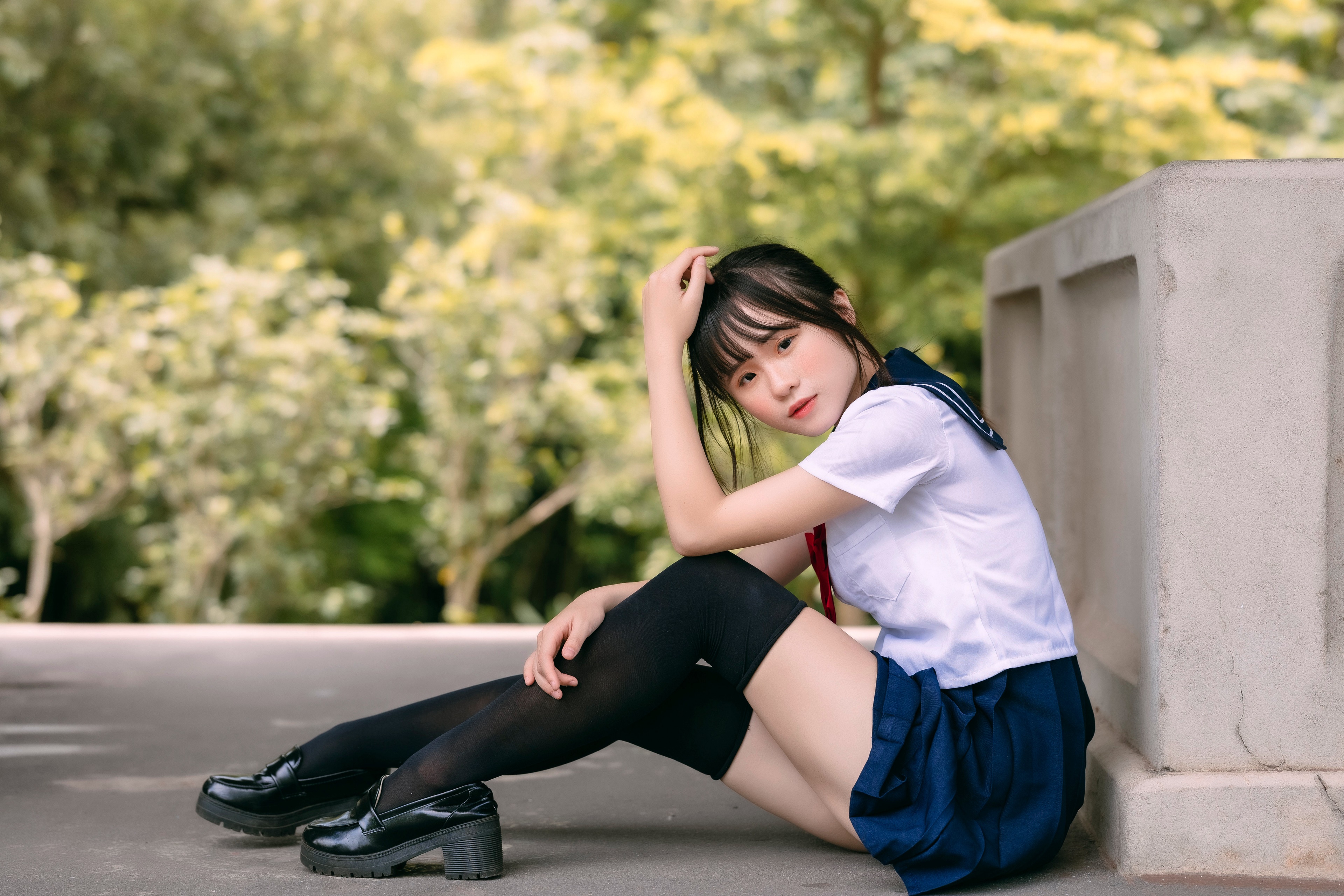 Asian girl in school uniform sitting outdoors HD Wallpaper