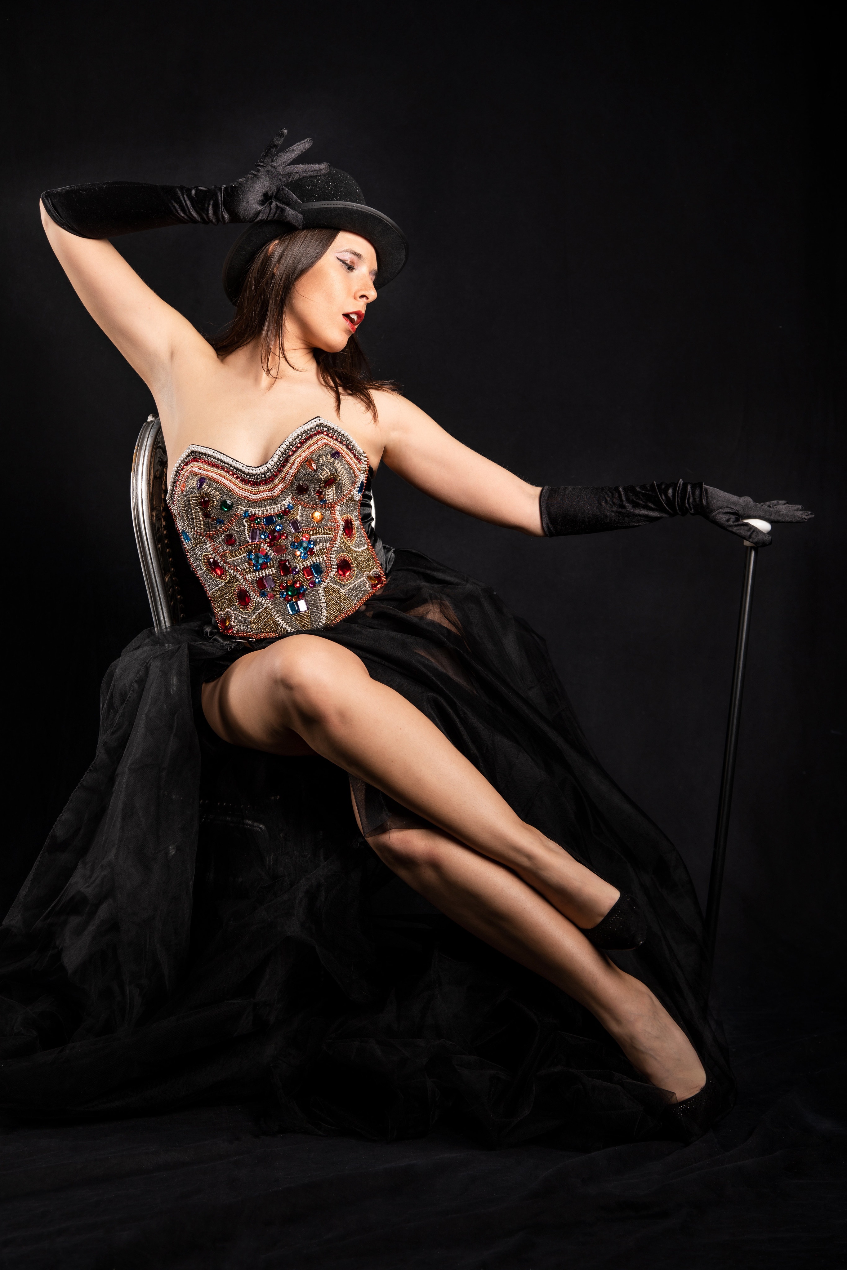 Woman in a sequined corset and black hat with cane HD Phone Wallpaper