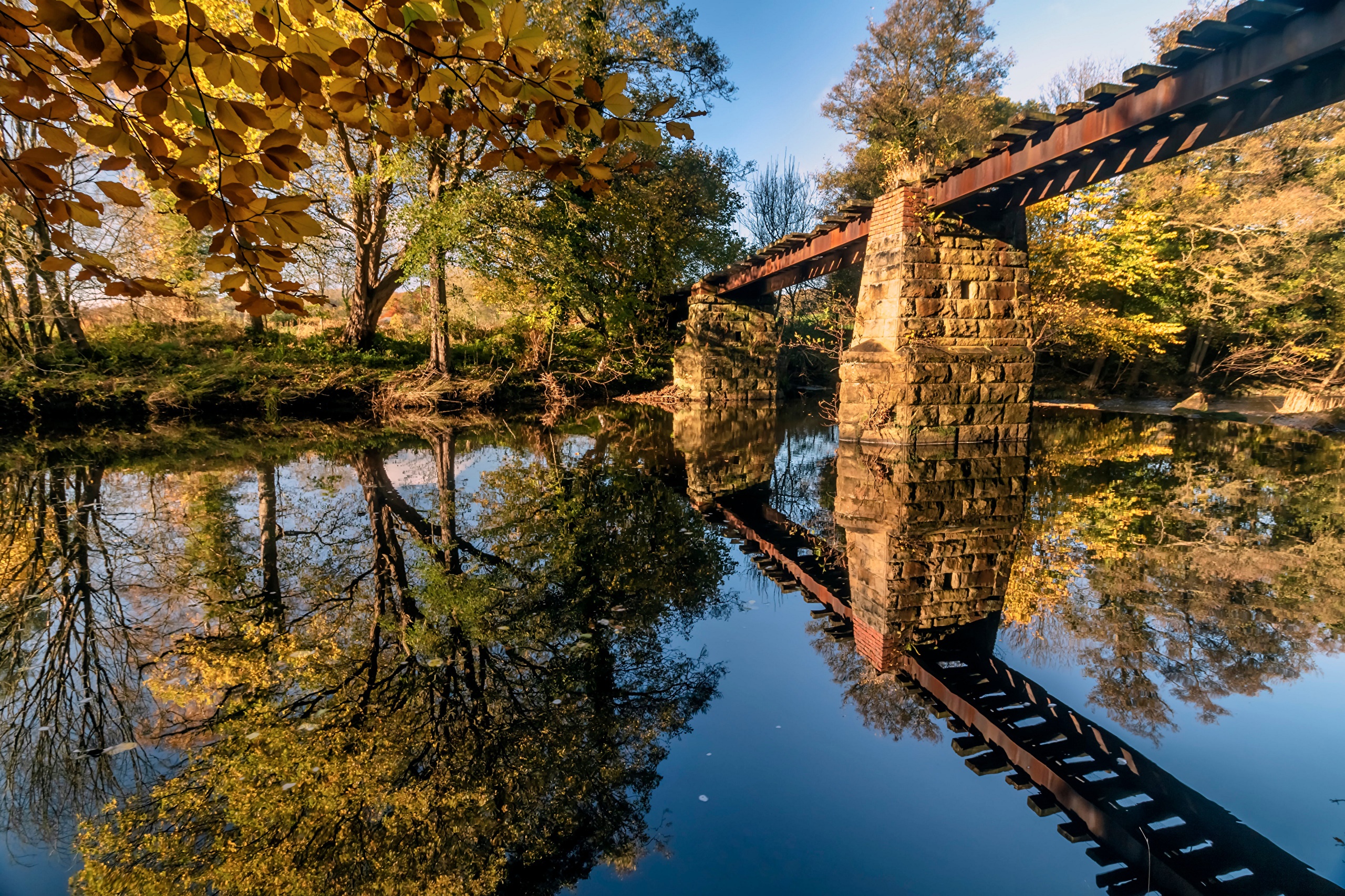 Old railway bridge over a river in Grosmont, England HD Wallpaper
