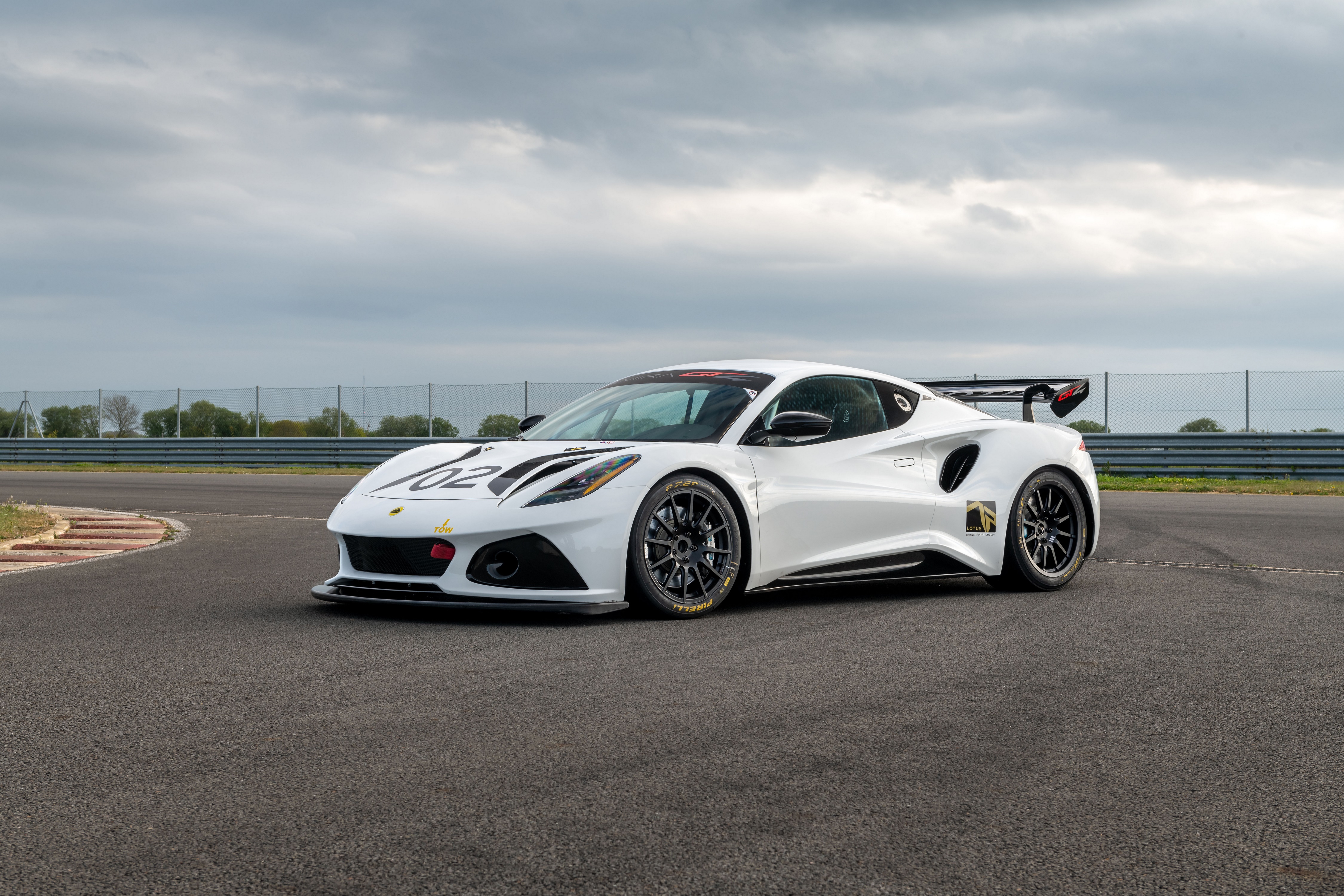 White Lotus Emira GT4 2022 on a race track HD Wallpaper