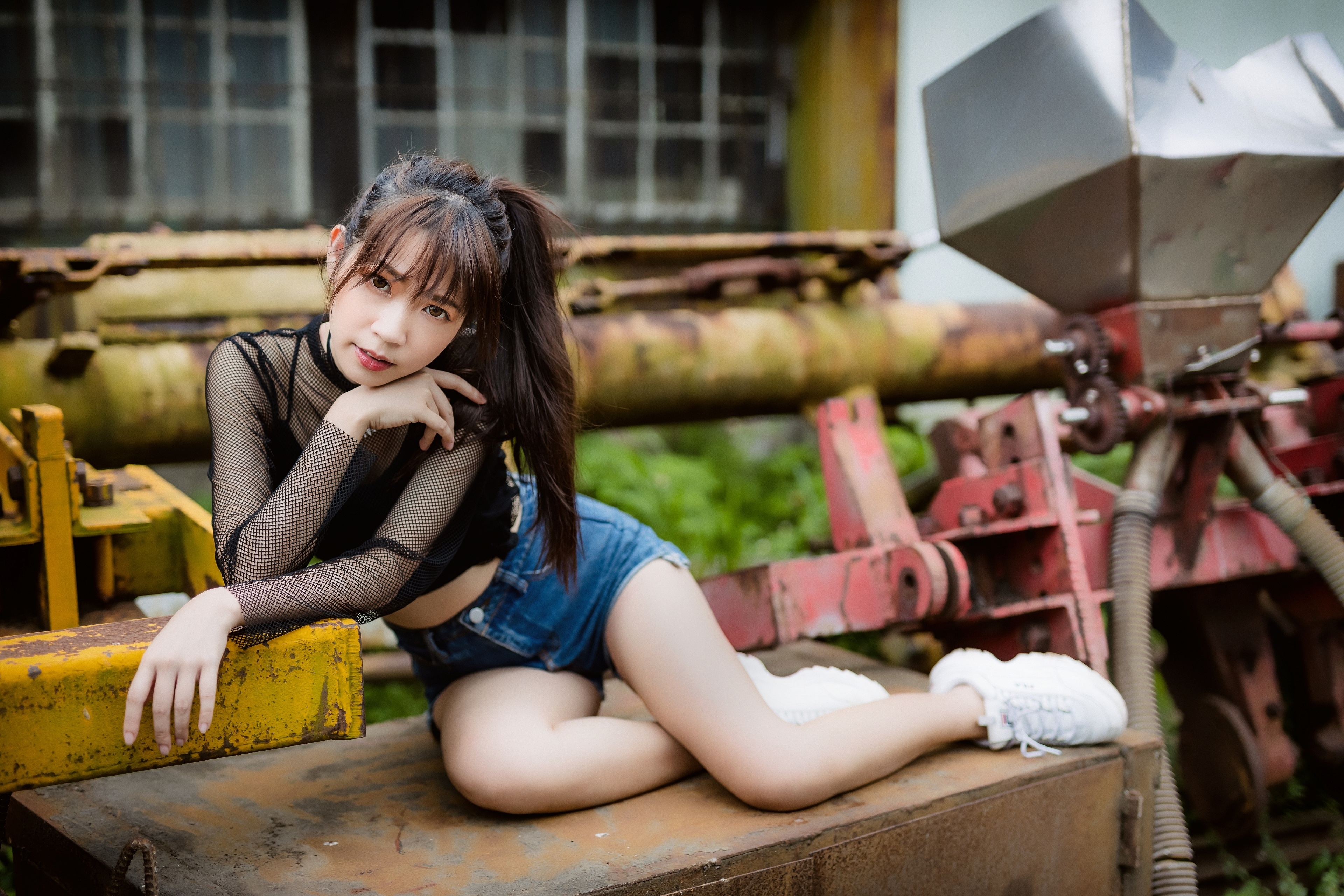 Asian girl in shorts and fishnet top outdoors HD Wallpaper
