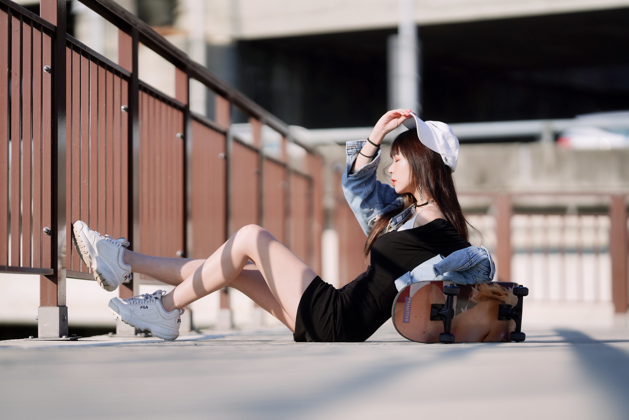 Asian girl with skateboard wearing baseball cap and dress HD Wallpaper