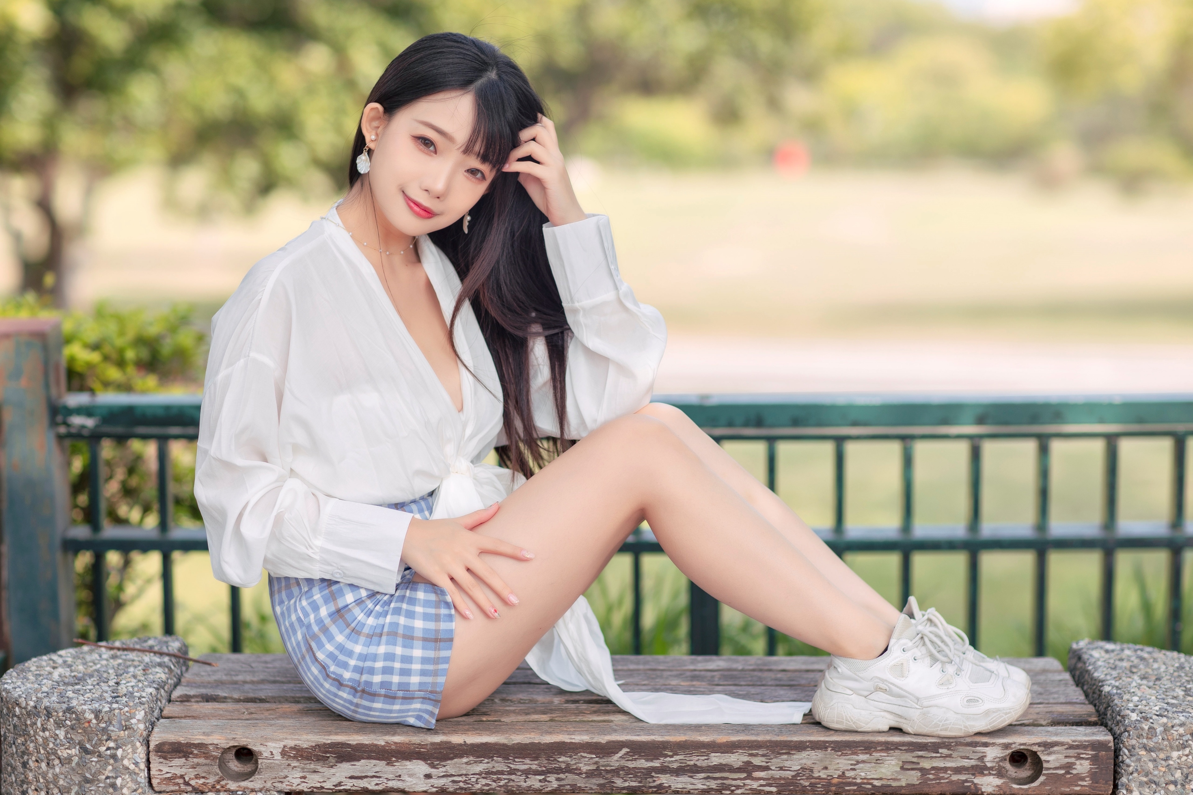 Asian girl in blouse and skirt sitting on bench HD Wallpaper