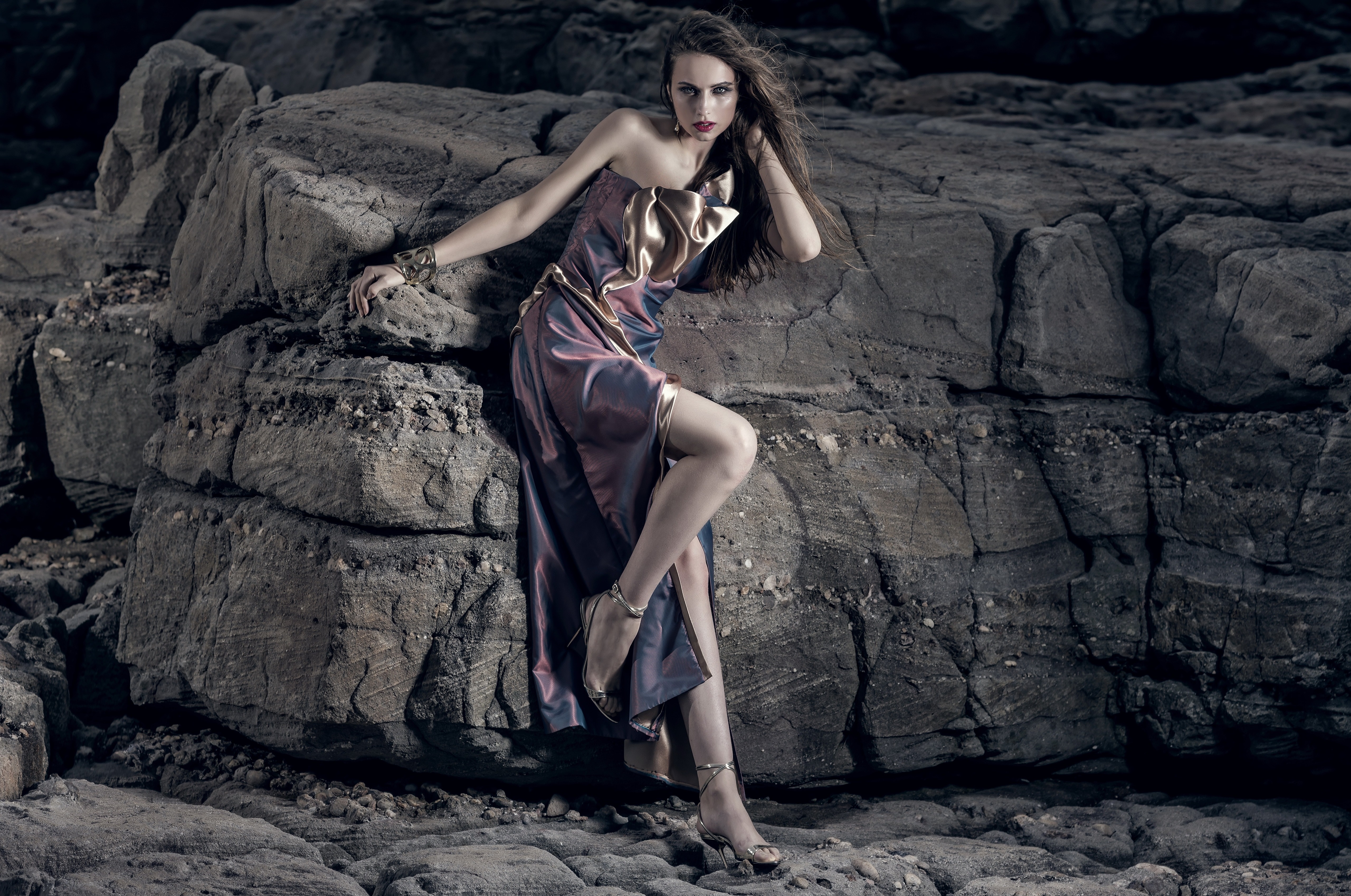 Model in a dress posing on rocks HD Wallpaper