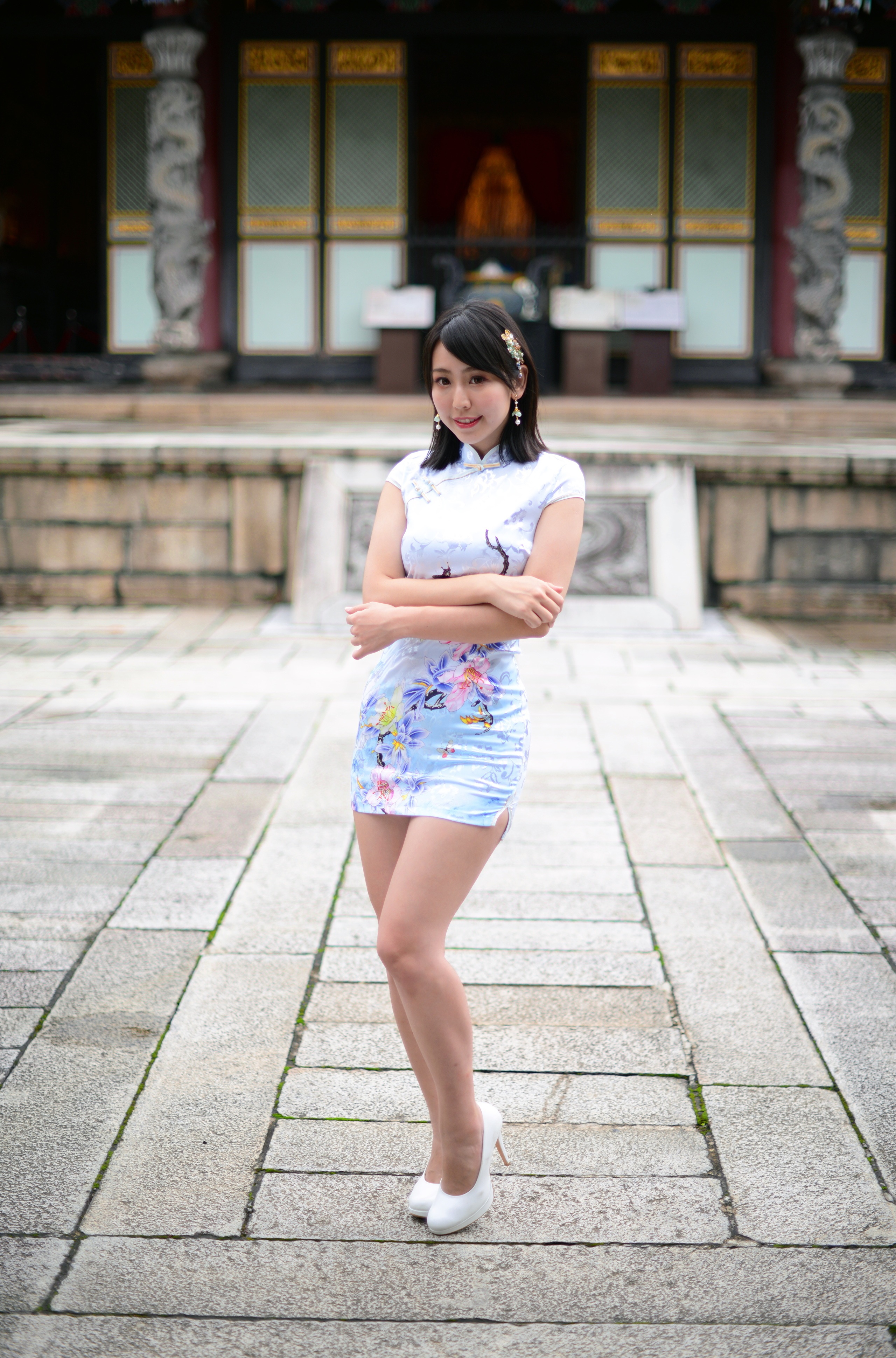 Woman in a floral dress posing in front of a temple HD Phone Wallpaper