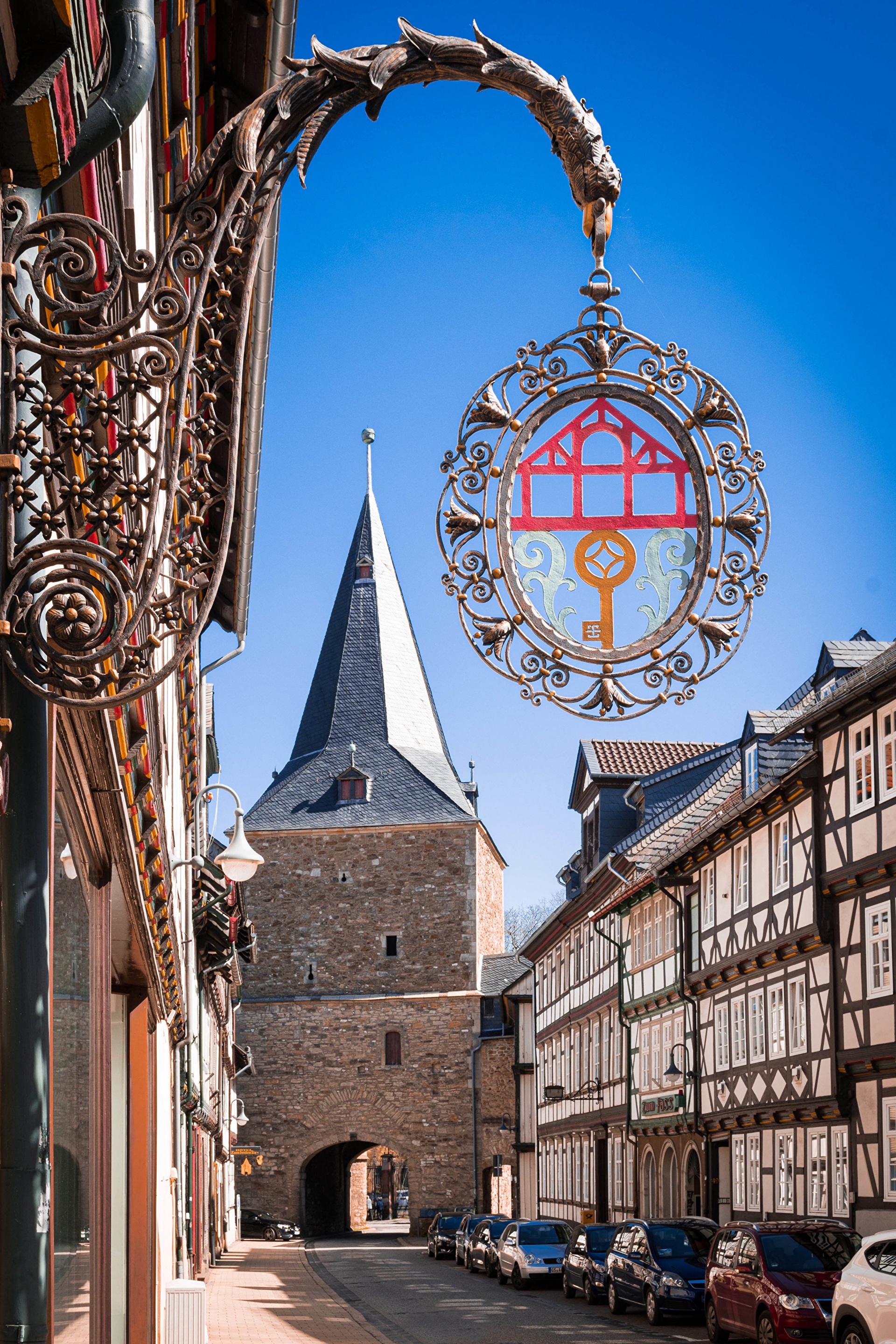 Street scene with historic buildings and tower in Goslar, Germany HD Phone Wallpaper