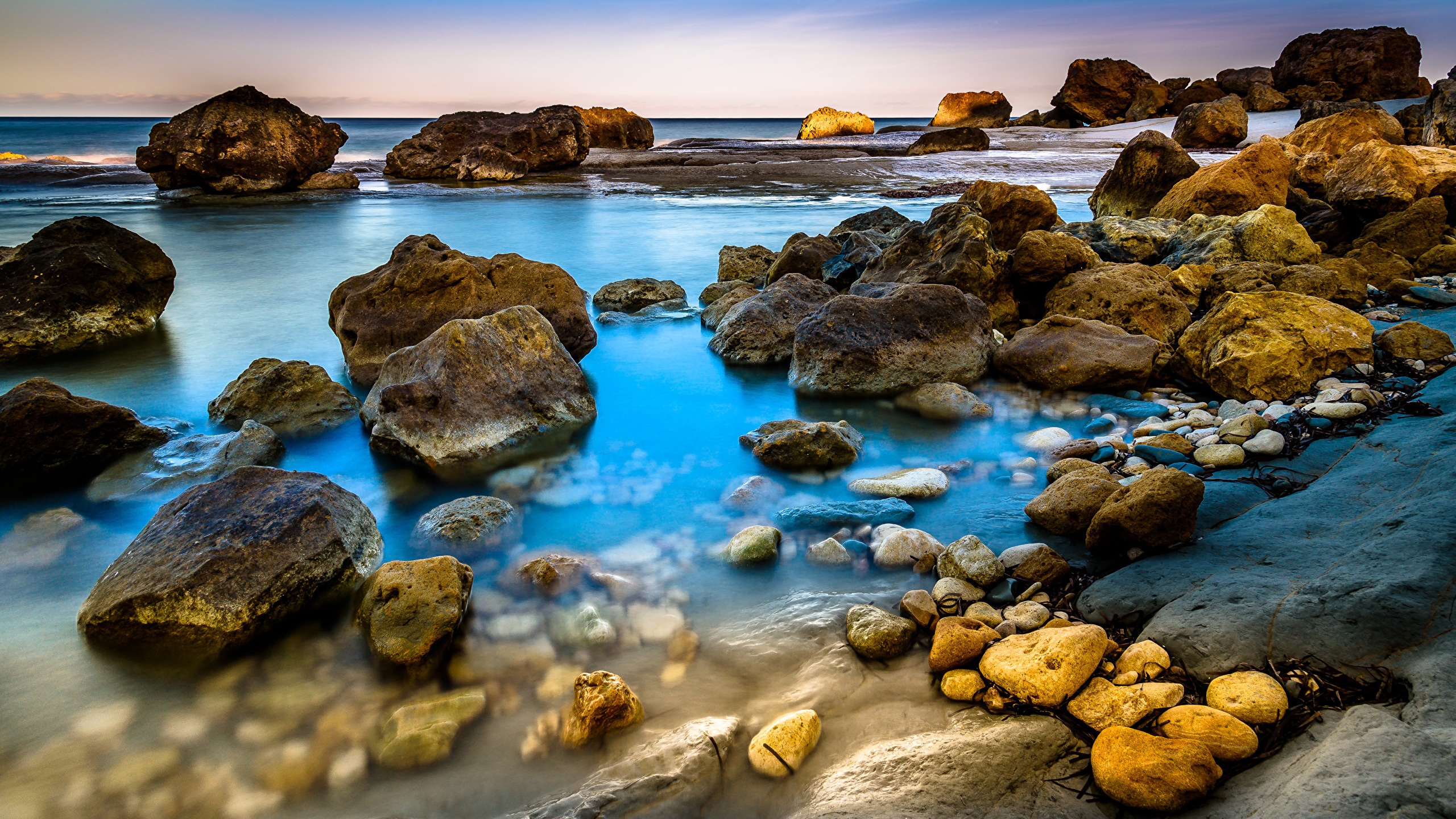 Rocky coastline with blue sea and sky HD Wallpaper