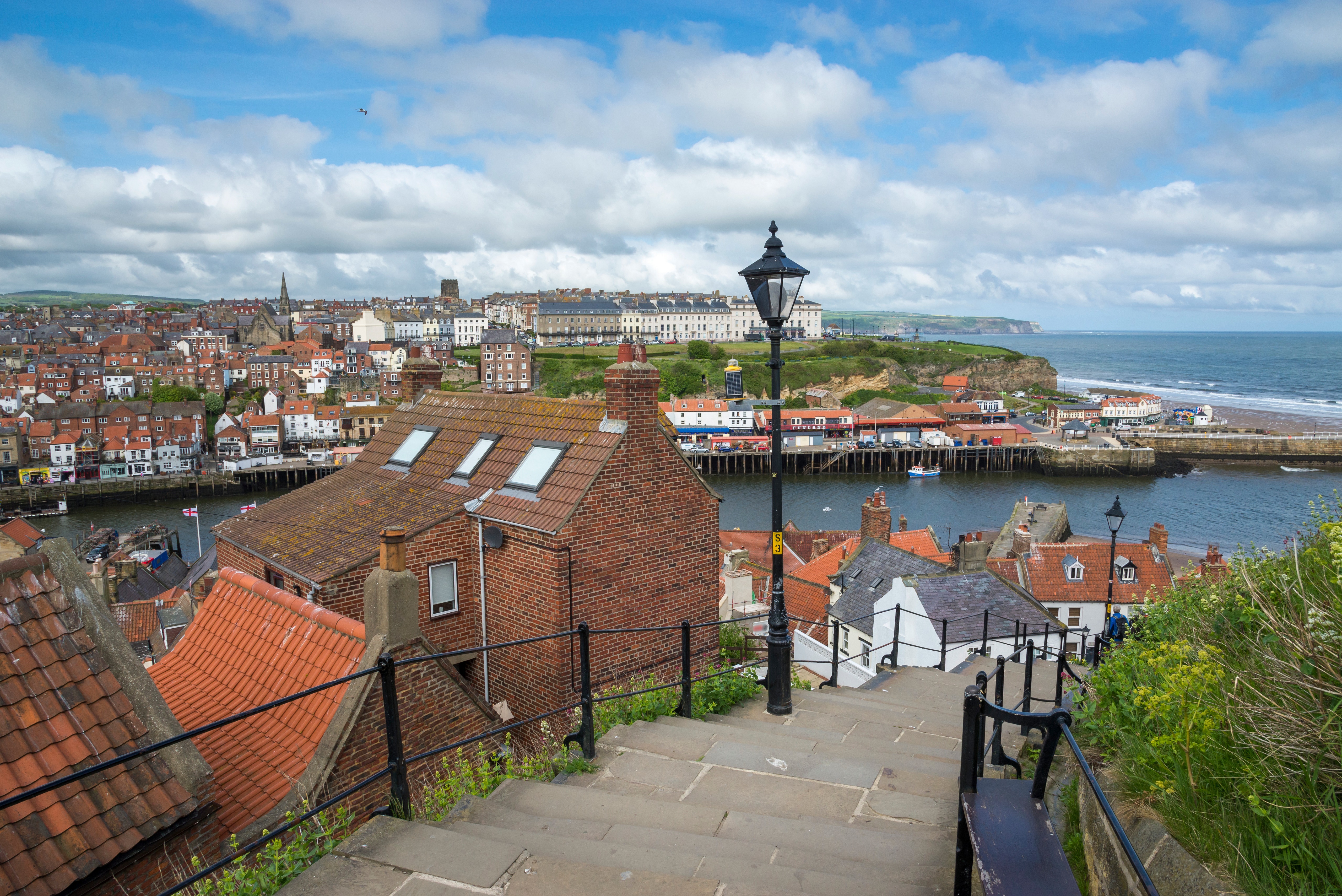 Whitby, England with coastal view and town HD Wallpaper