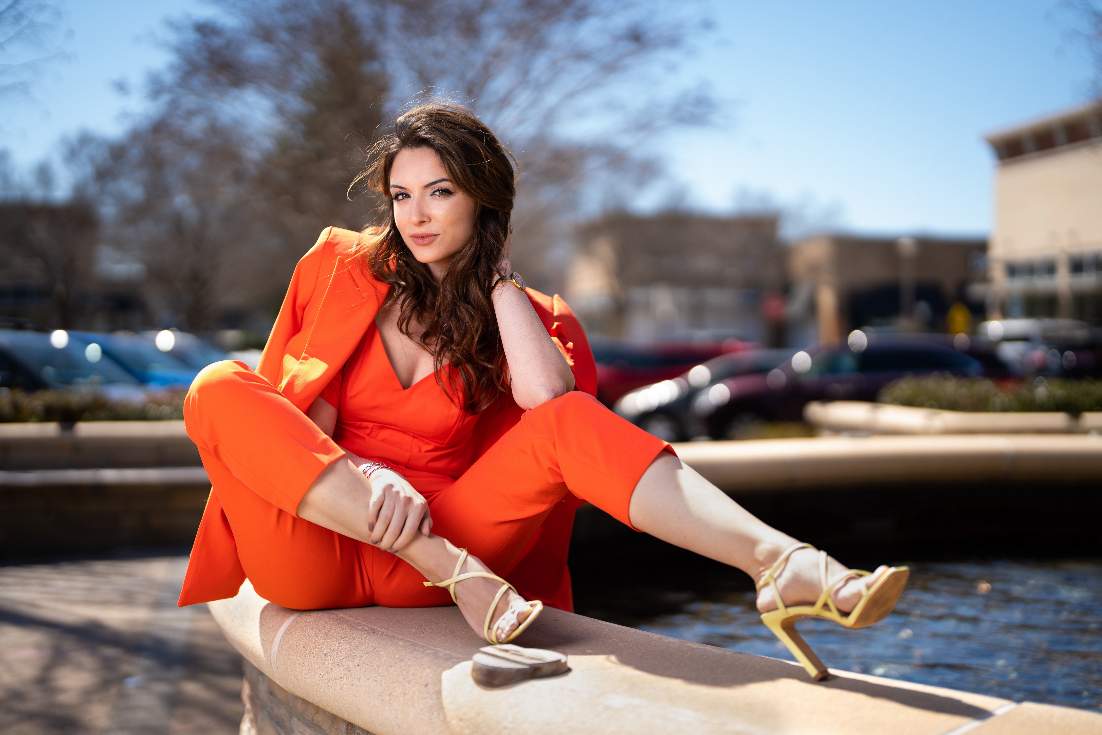 Madi in Orange Suit Sitting Outdoors HD Wallpaper