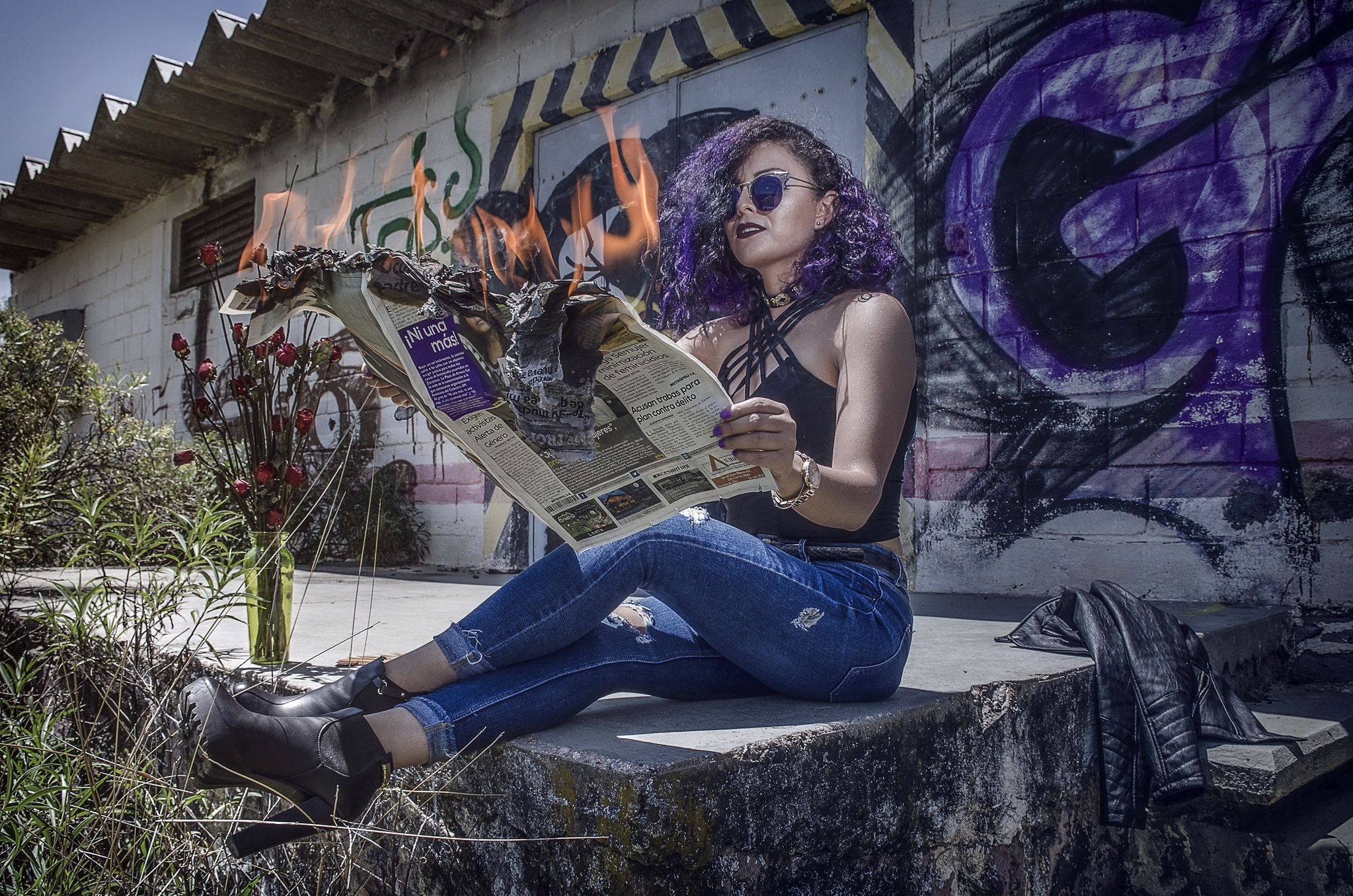 Woman burning newspaper while sitting outdoors HD Wallpaper