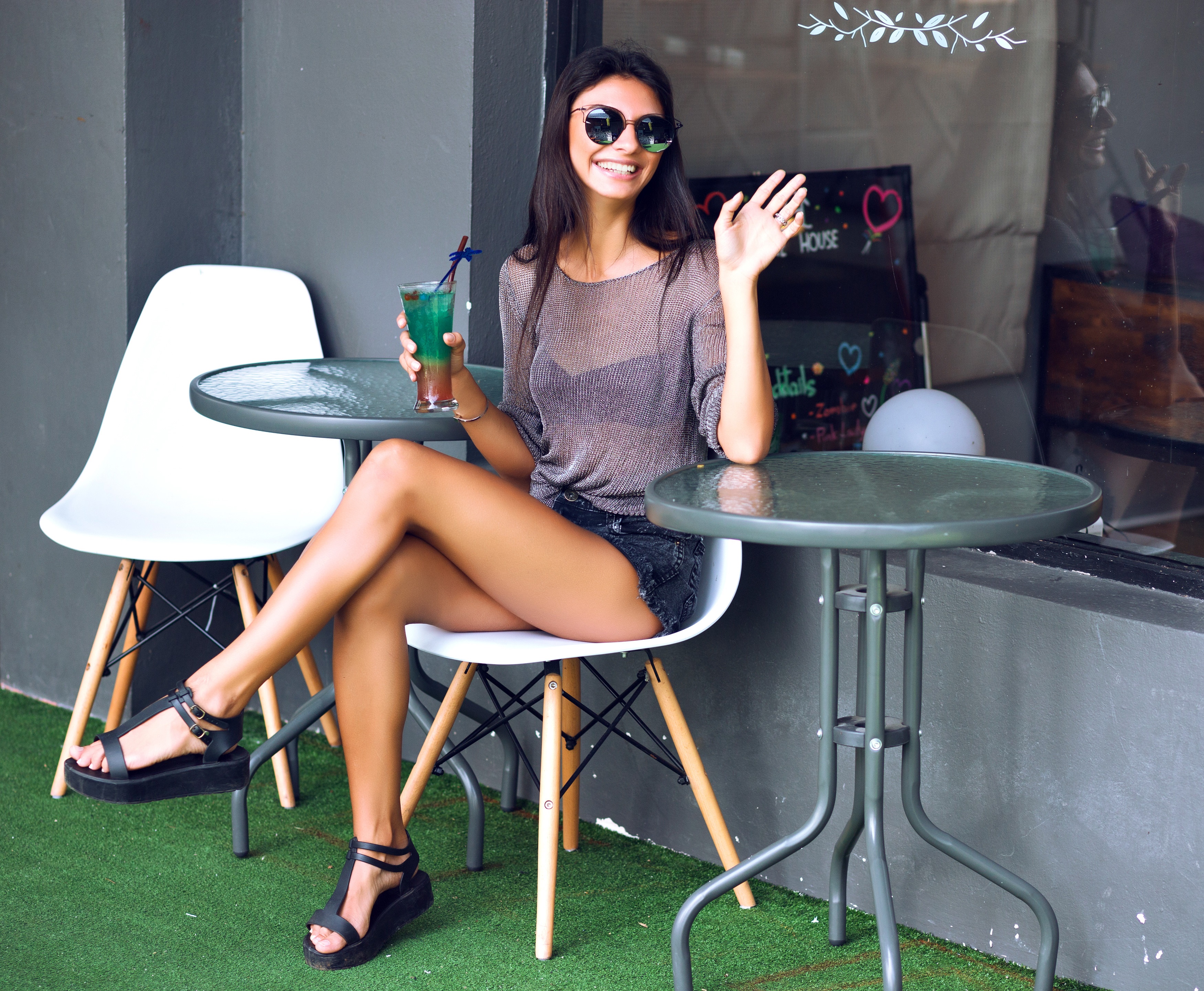 Brunette girl with sunglasses holding a drink at a cafe HD Wallpaper