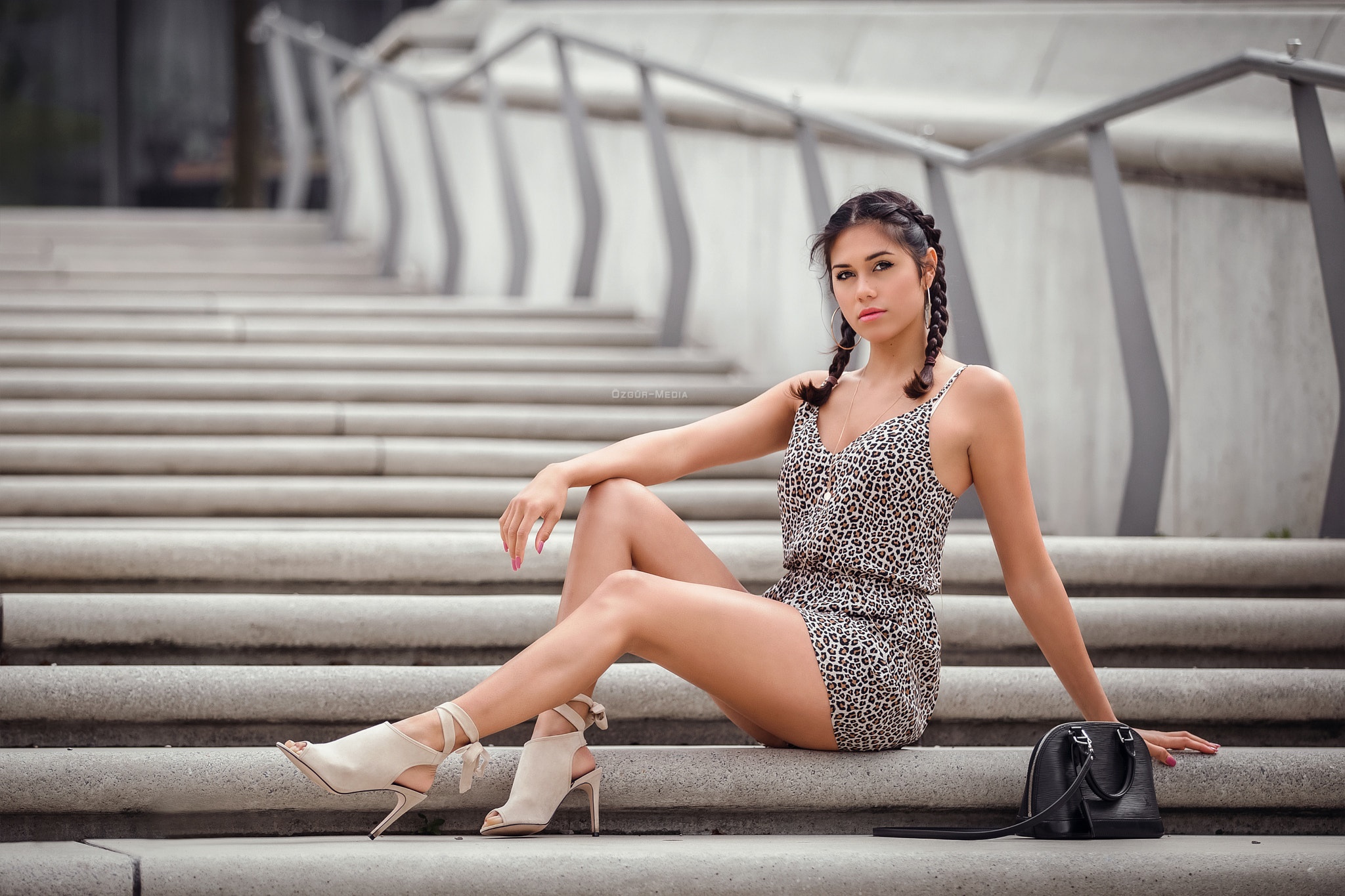 Woman with braided hair sitting on stairs with handbag HD Wallpaper