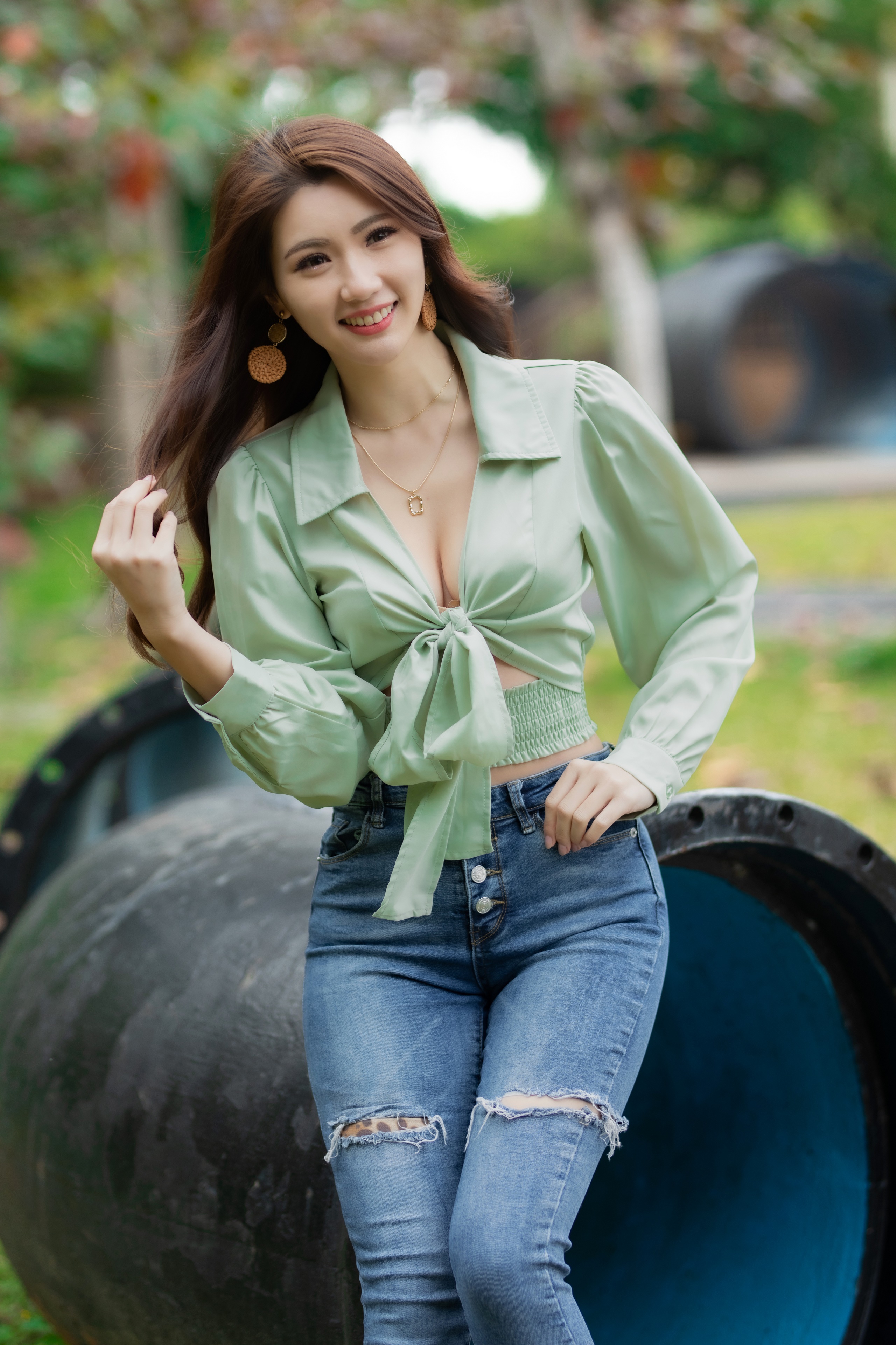 Asian woman in blouse and jeans smiling HD Phone Wallpaper