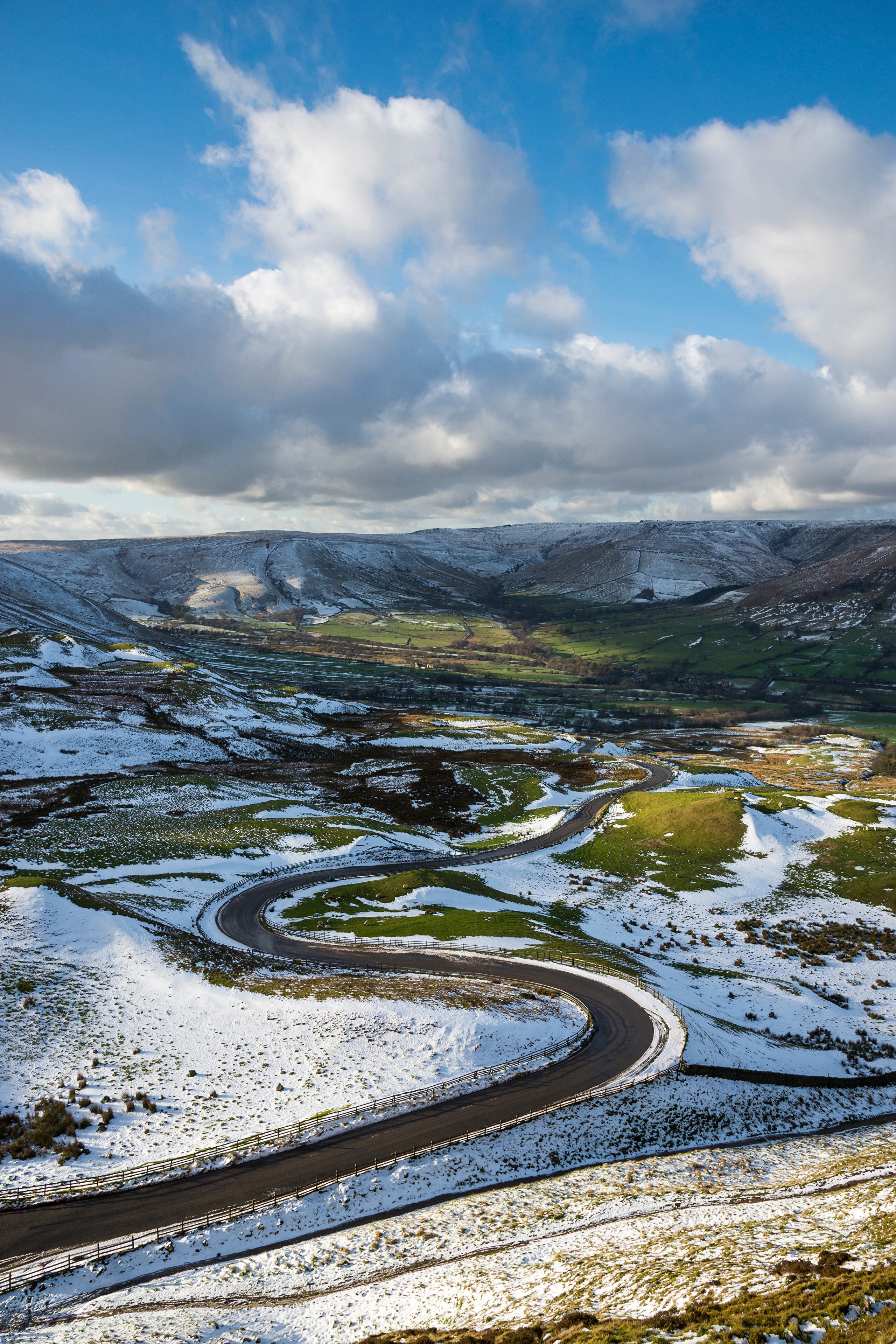 Snowy Peak District road with clouds HD Phone Wallpaper