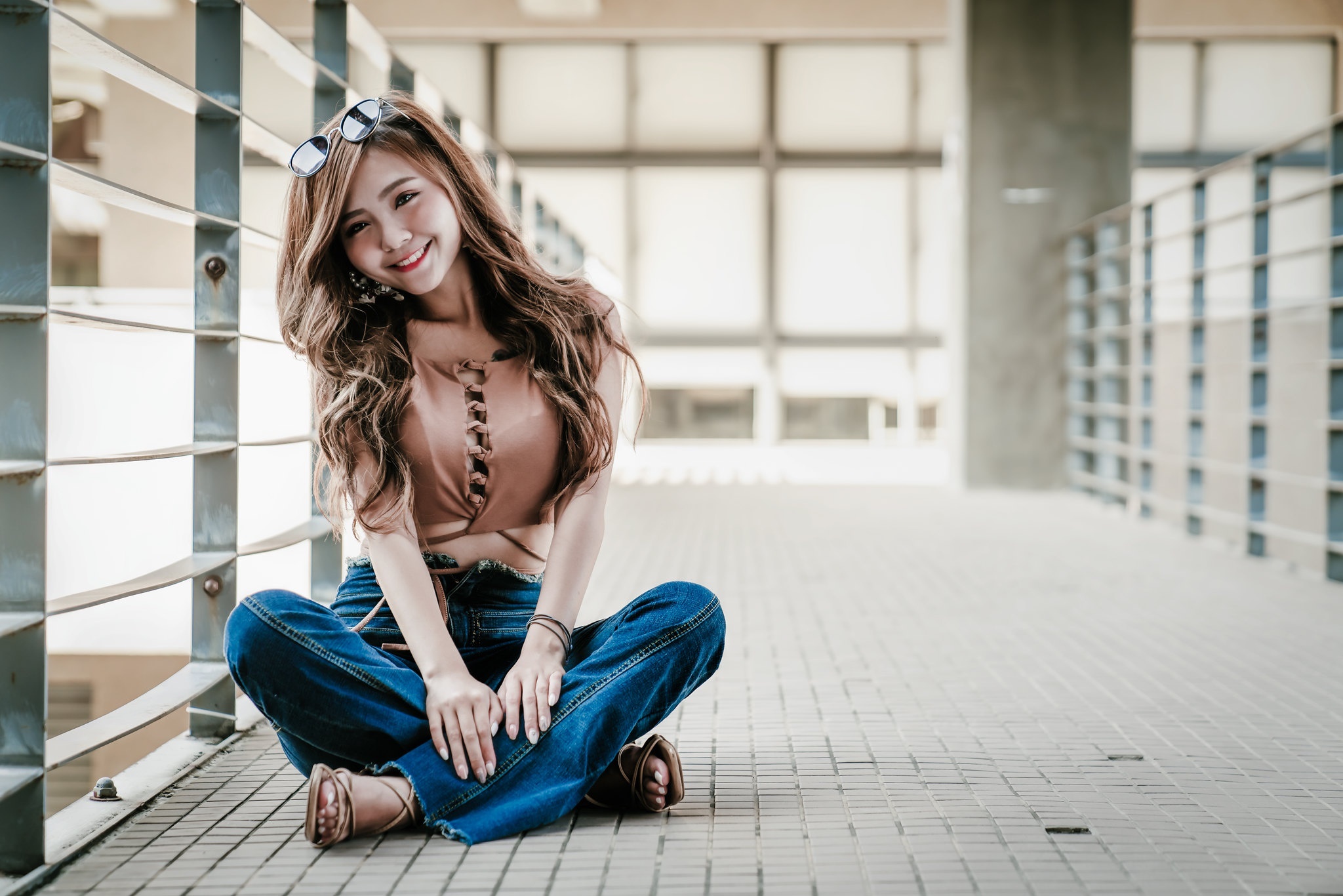Asian woman with brown hair wearing jeans and sunglasses HD Wallpaper
