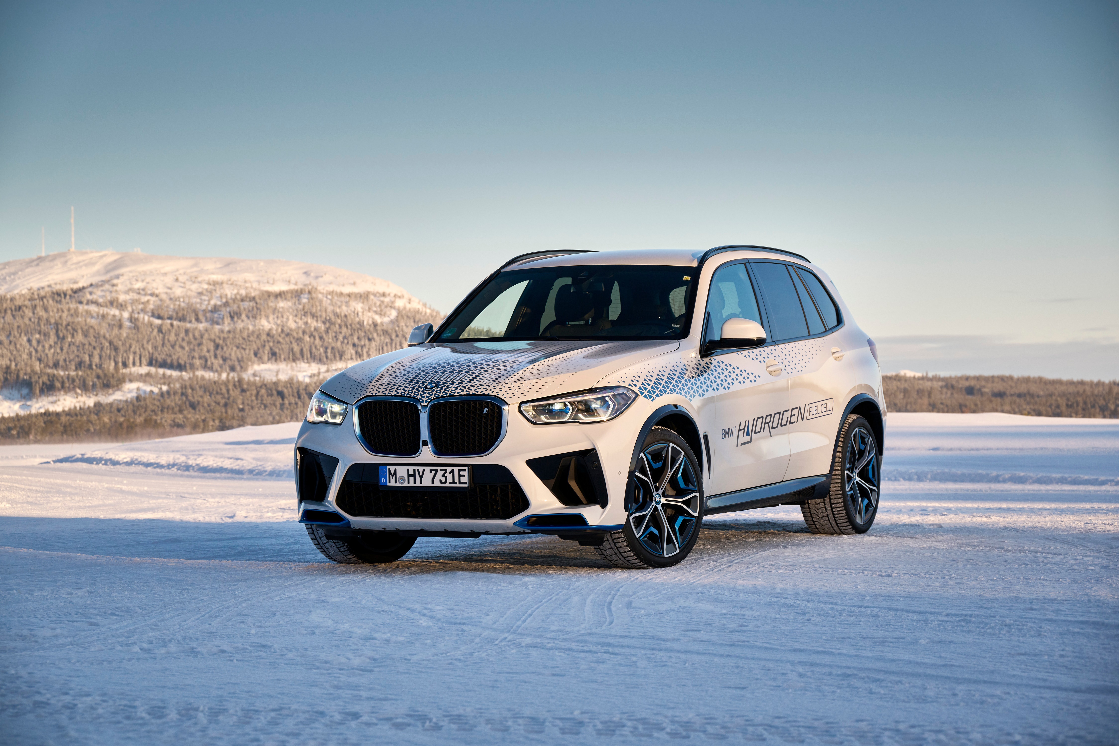 BMW iX5 Hydrogen crossover in snowy landscape HD Wallpaper