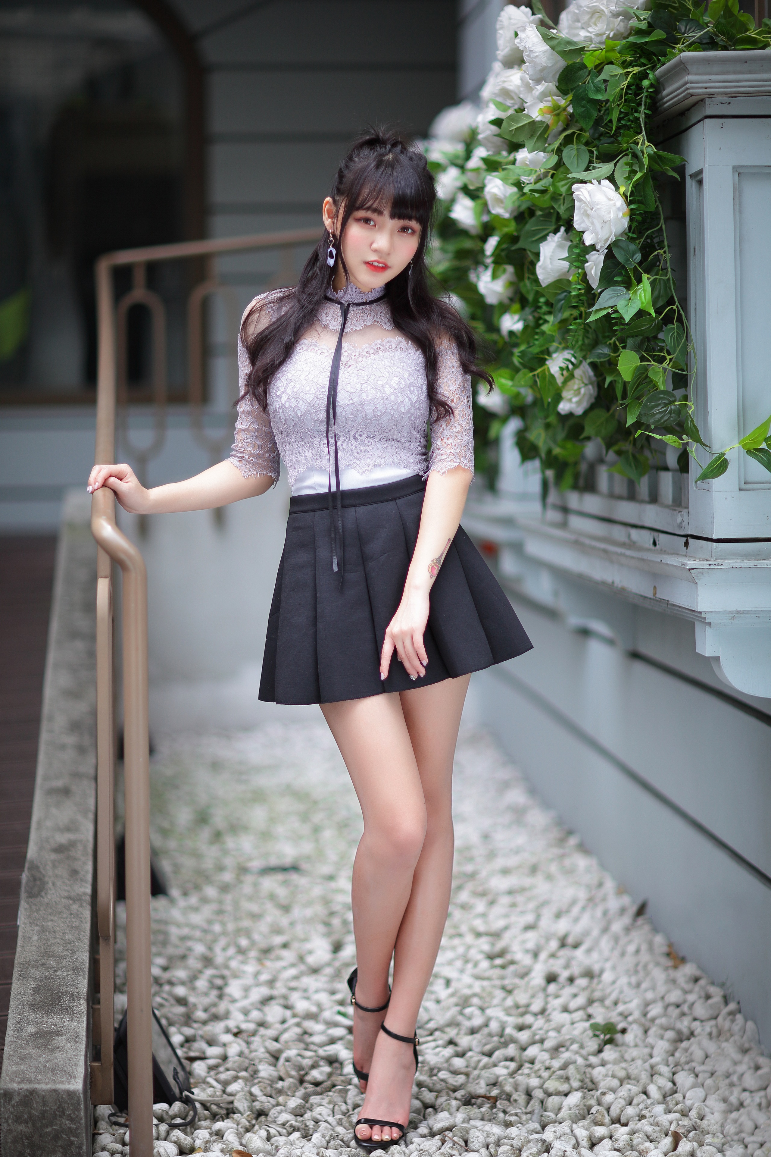 Asian girl in lace top and black skirt posing outdoors HD Phone Wallpaper