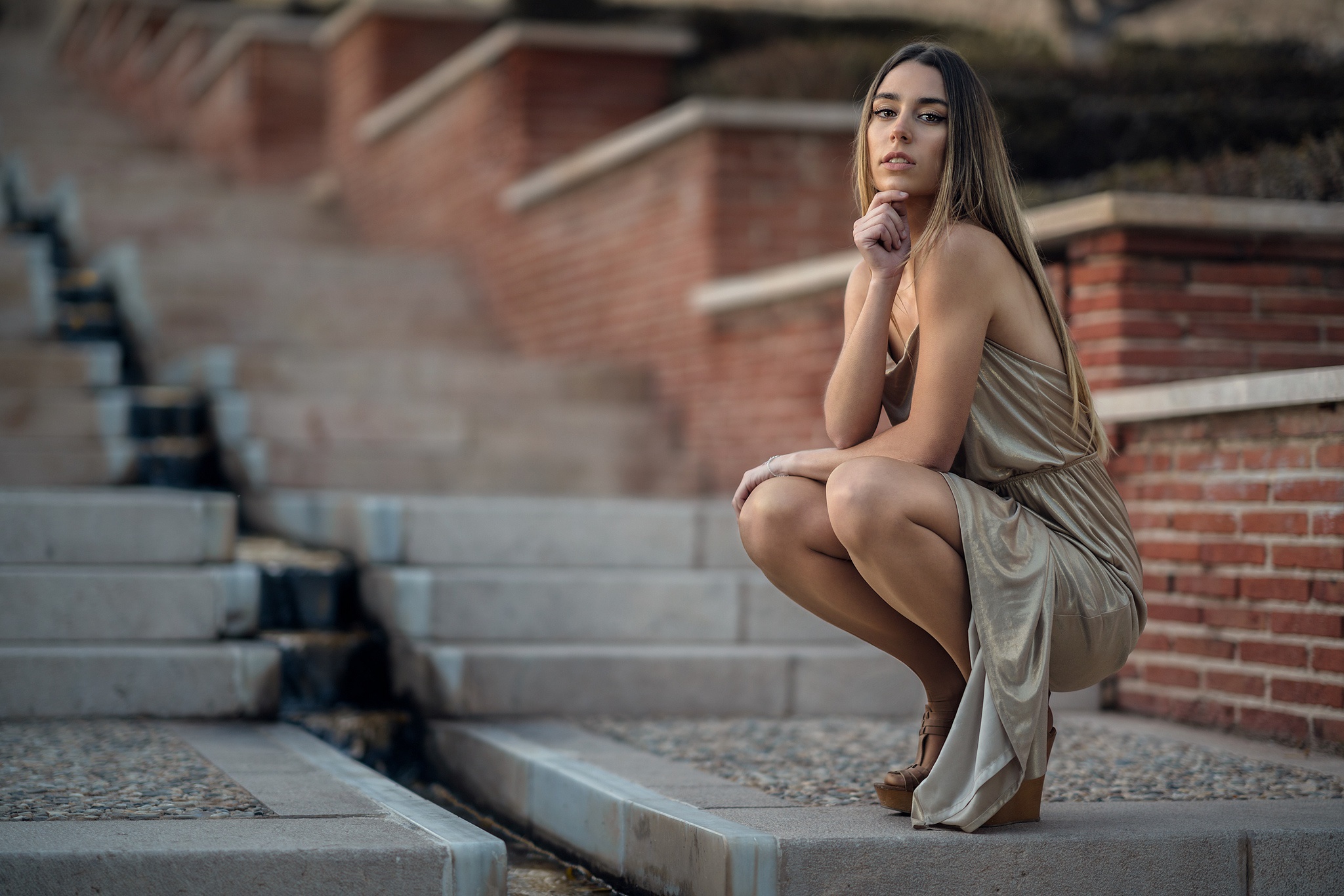 Woman in a gold dress posing on steps HD Wallpaper