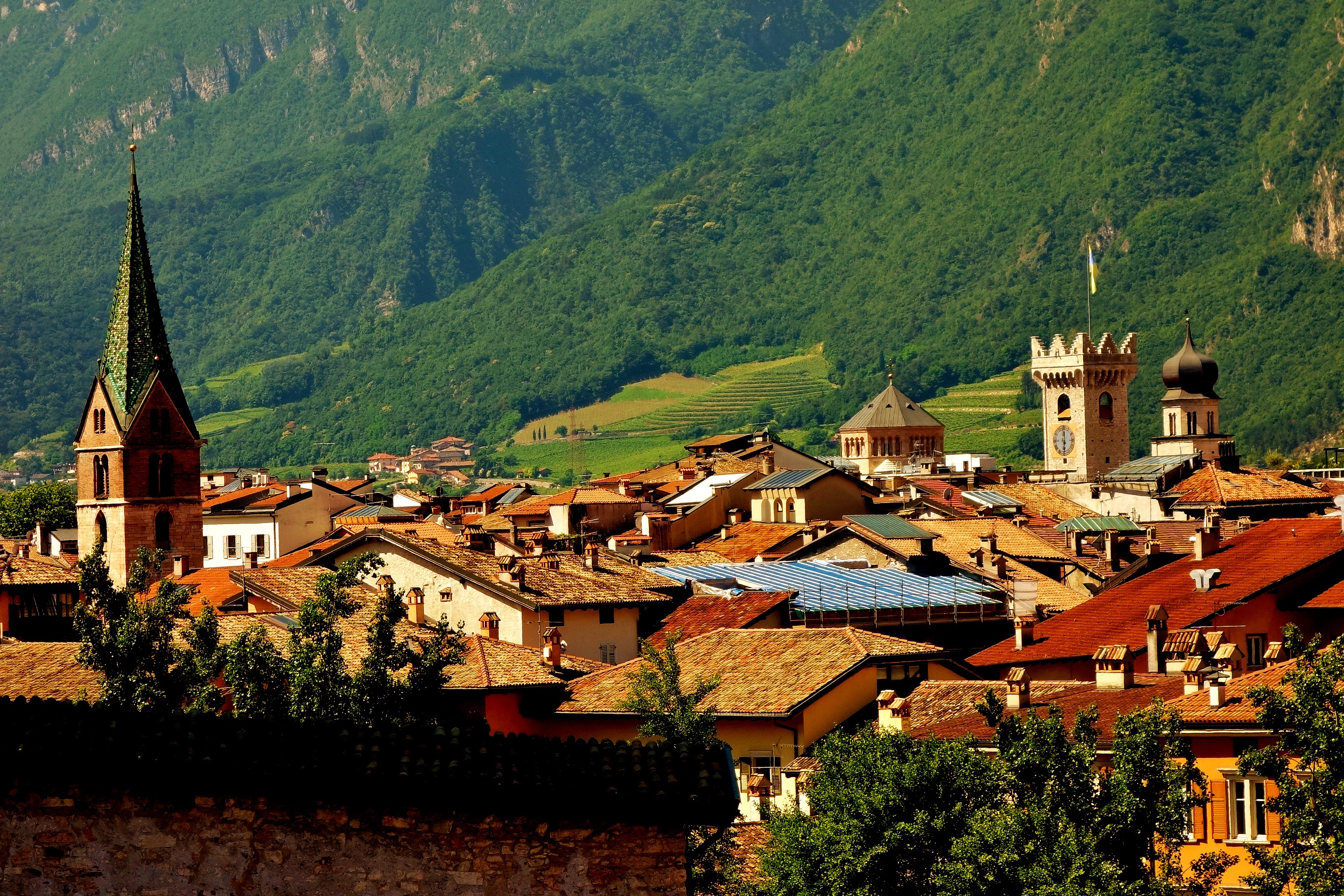 Town with church spires and mountains in Trento, Italy HD Wallpaper