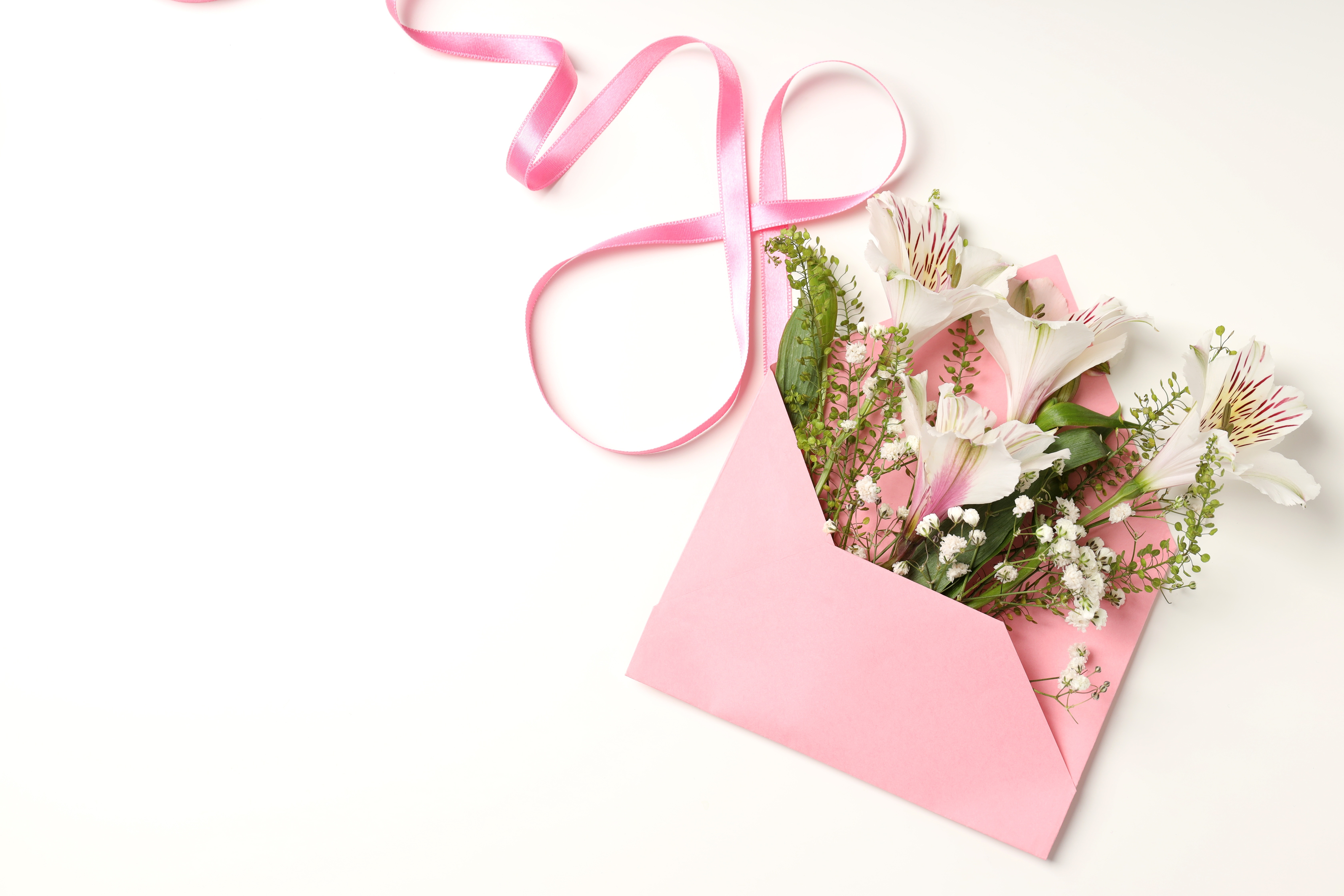 Bouquet of flowers in a pink envelope with a pink ribbon HD Wallpaper