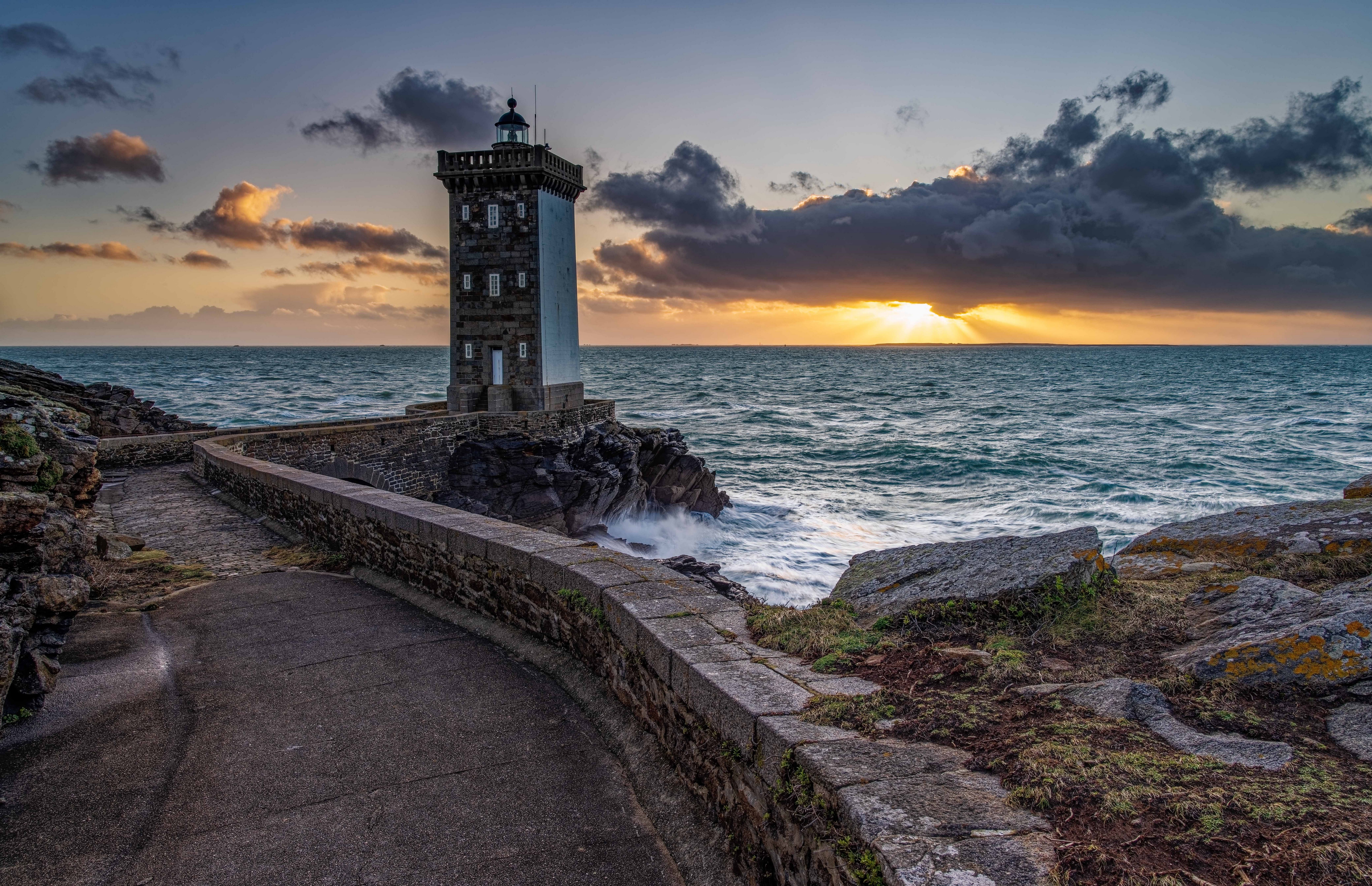 Lighthouse on the coast of Brittany, France at sunset HD Wallpaper