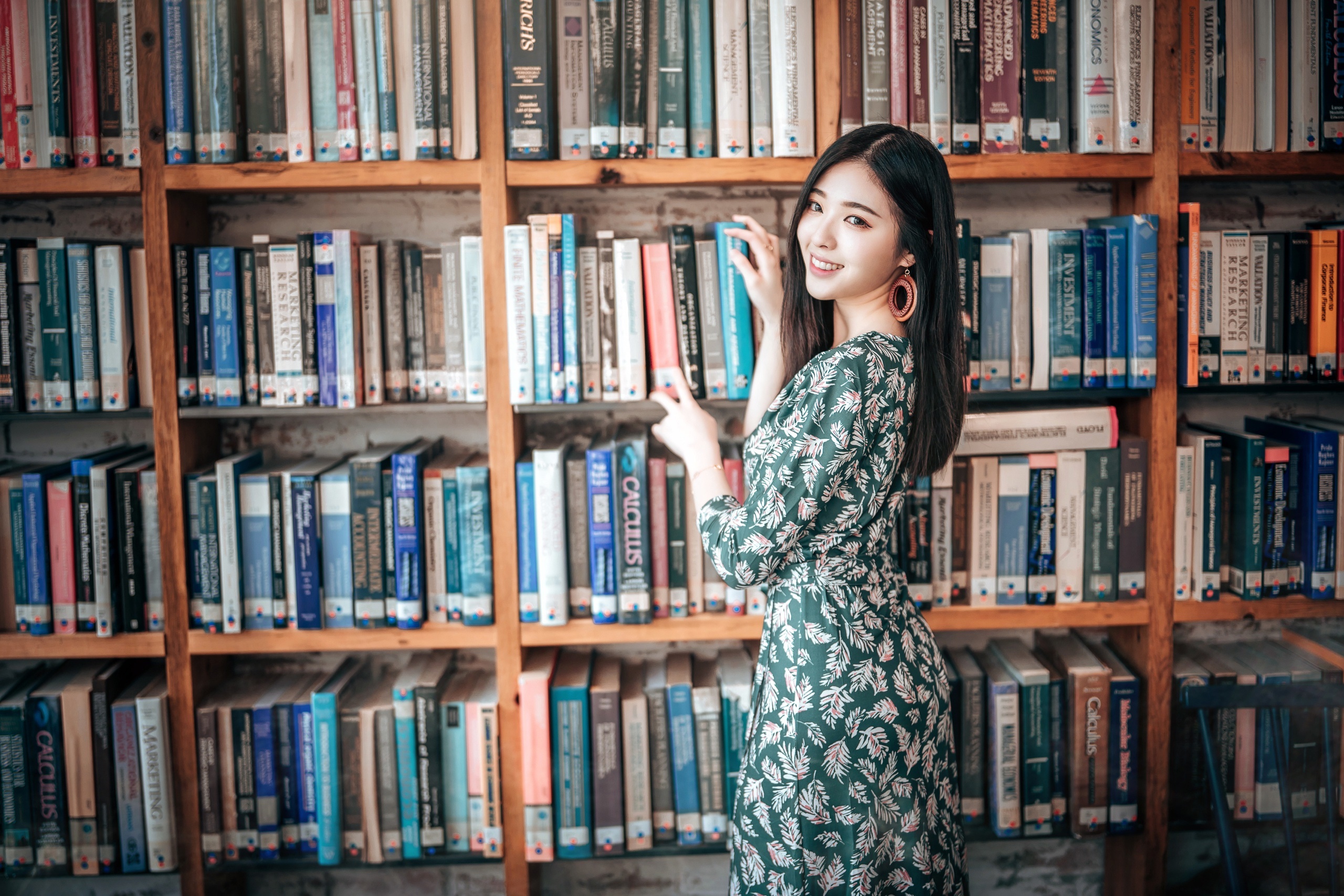 Asian woman in a dress in a library HD Wallpaper
