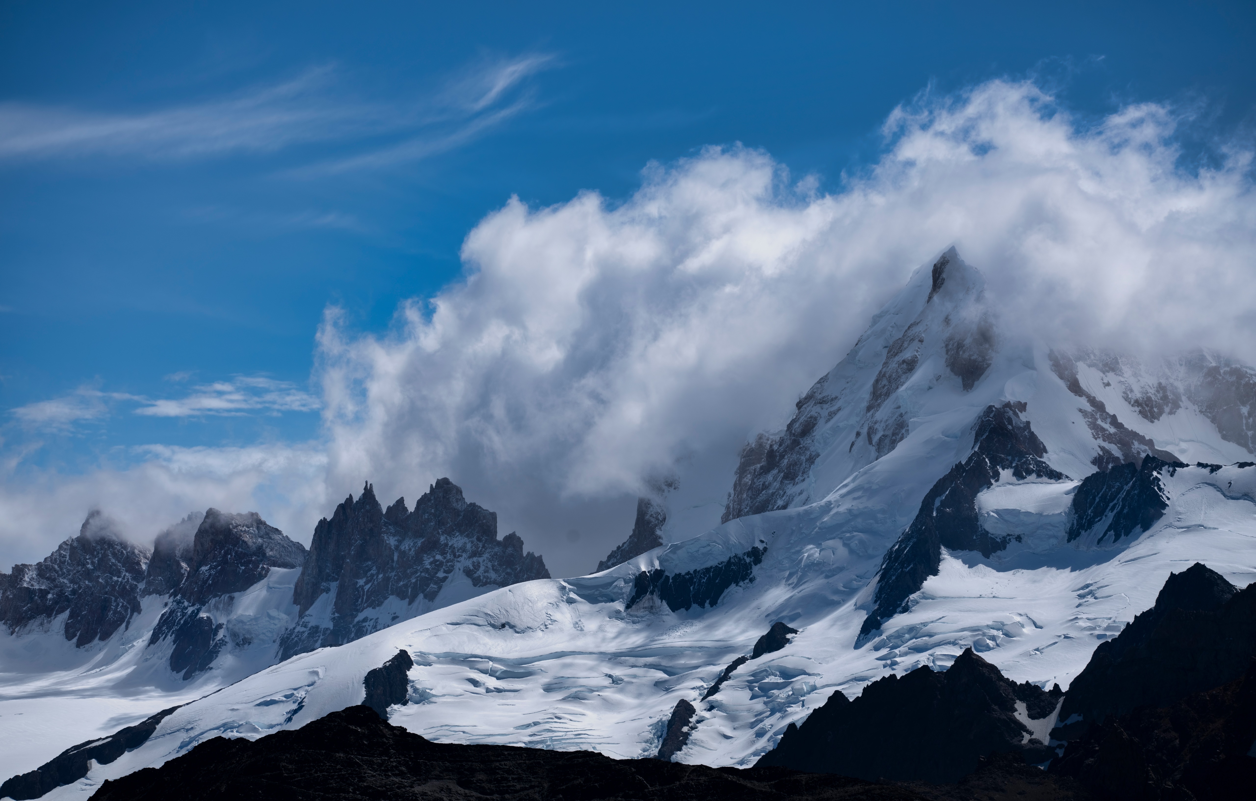 Snow-covered mountains in Patagonia, Argentina, with clouds HD Wallpaper