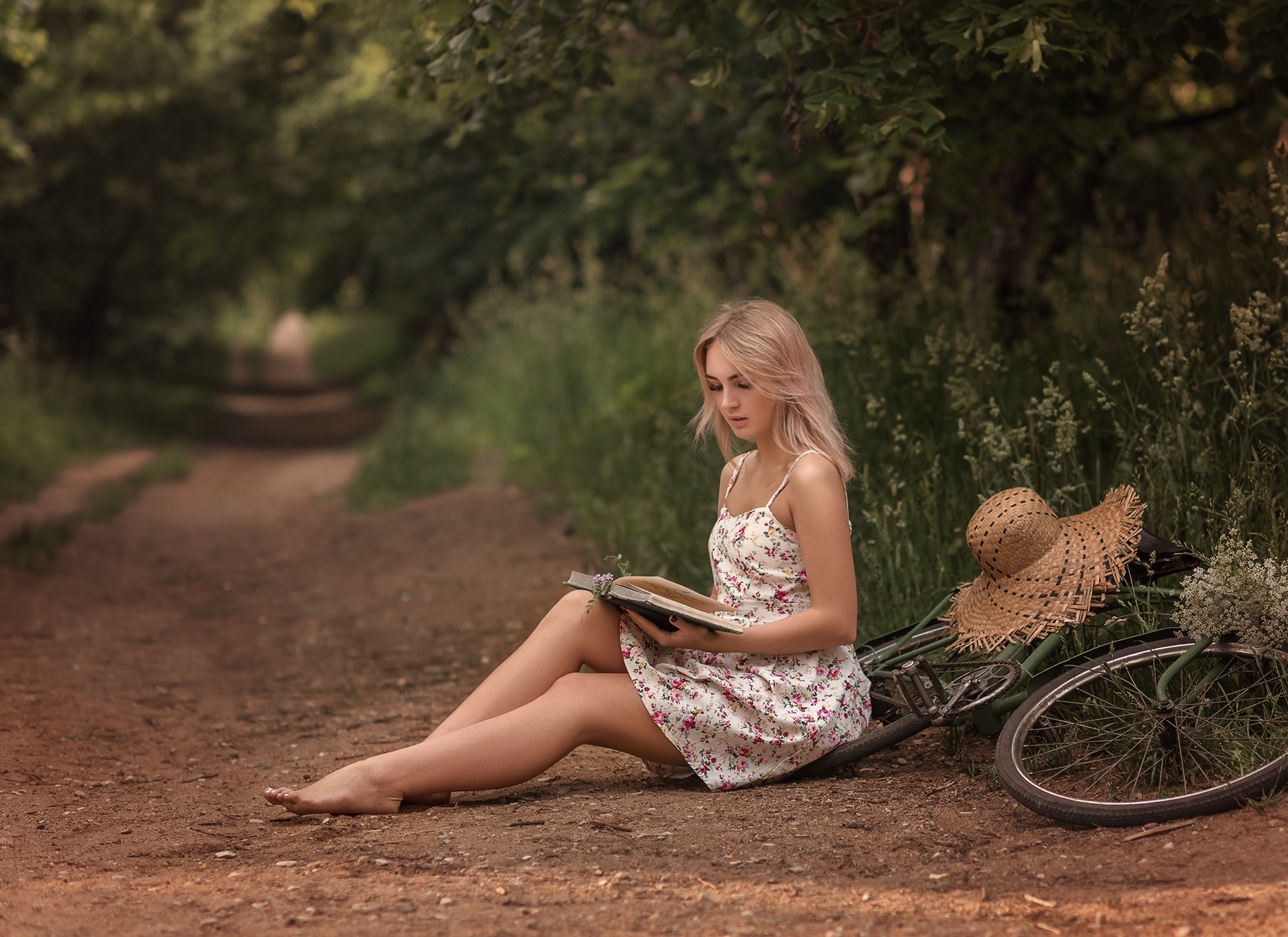 Blonde girl reading a book by a bicycle HD Wallpaper