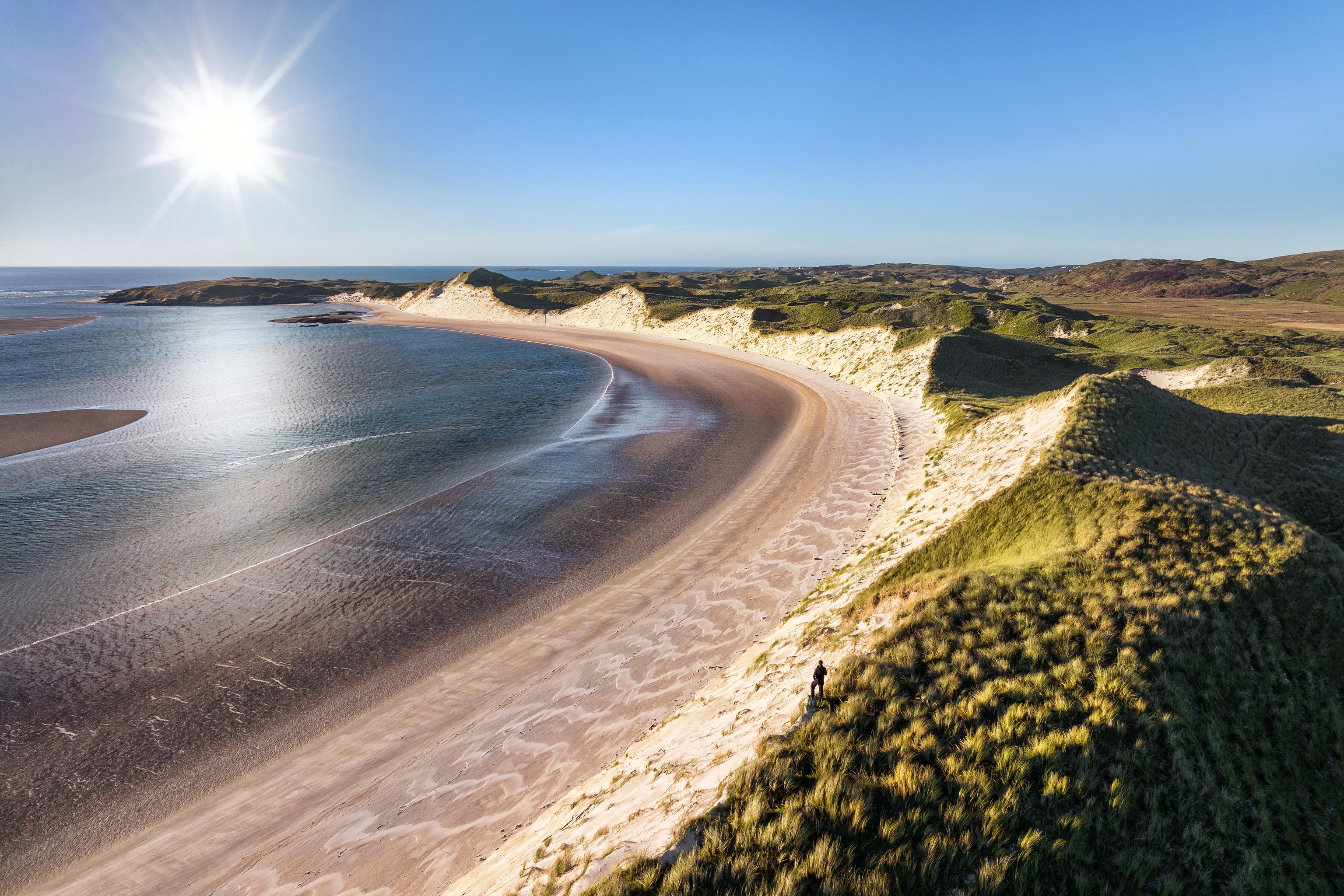 Person on sand dunes overlooking Donegal coast, Ireland HD Wallpaper