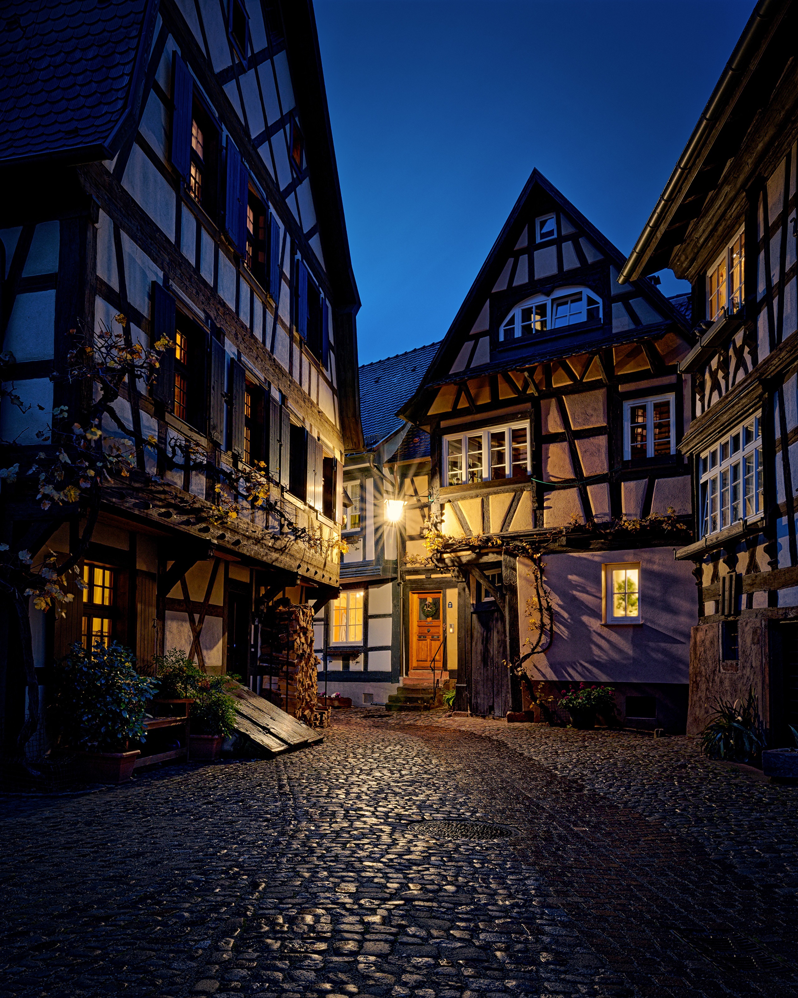 Gengenbach, Germany: Timber-framed houses on a cobblestone street at night HD Phone Wallpaper