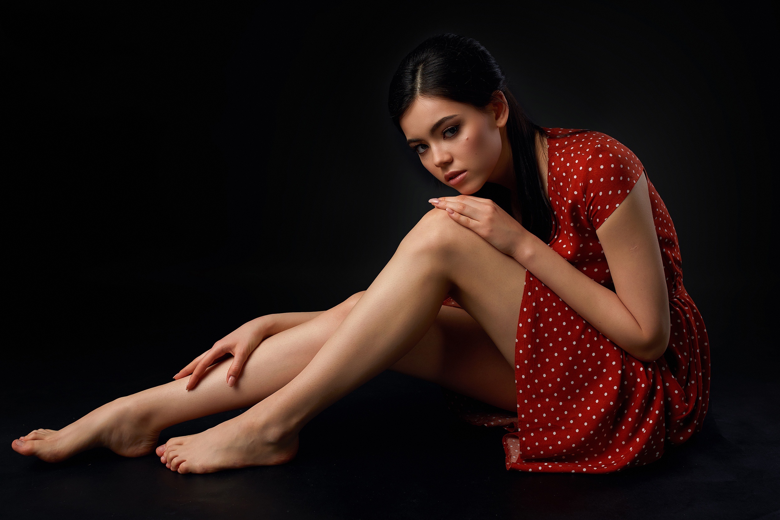 Brunette girl in red polka dot dress sitting HD Wallpaper