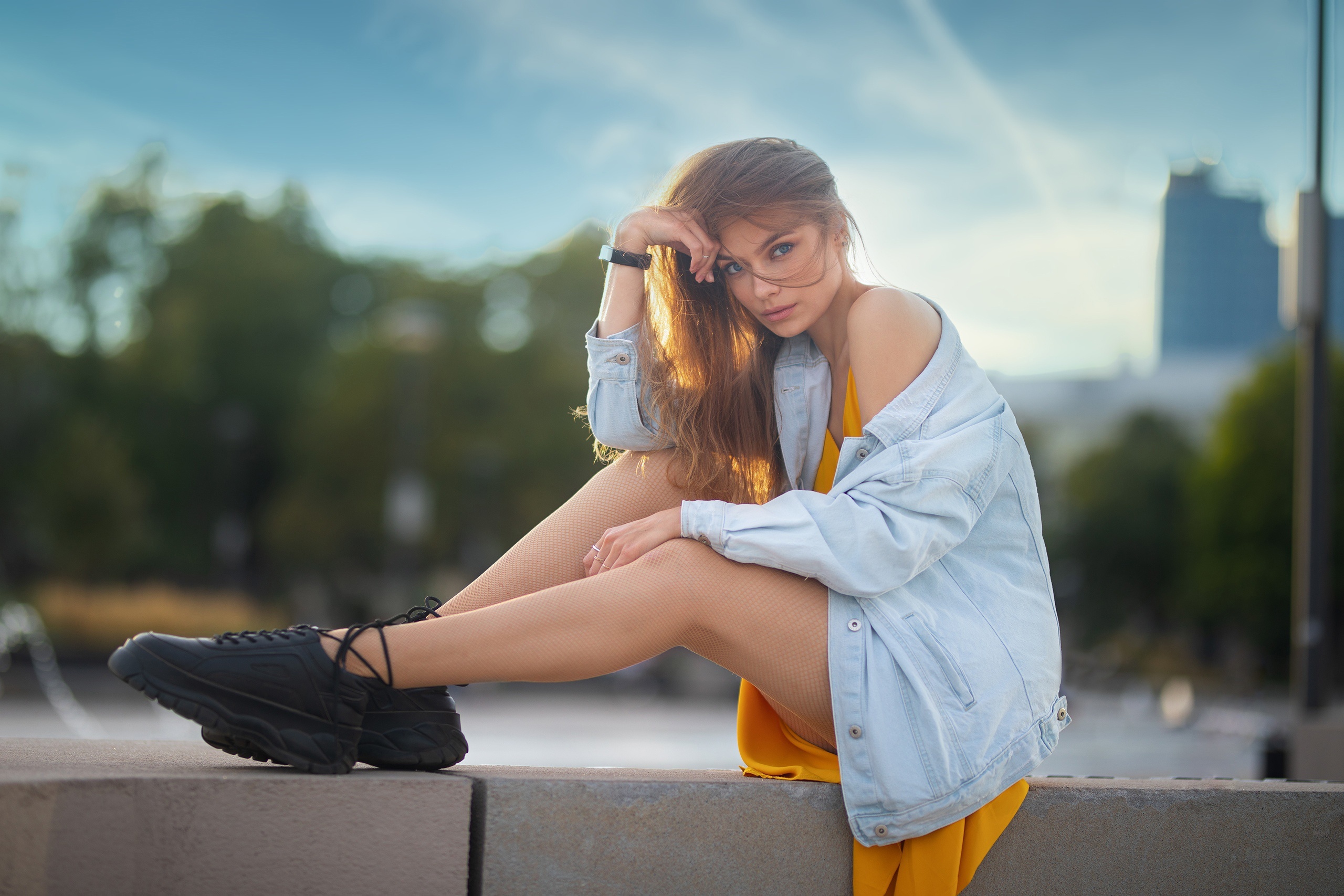 Ekaterina Klat sitting outdoors wearing a denim jacket and yellow dress HD Wallpaper